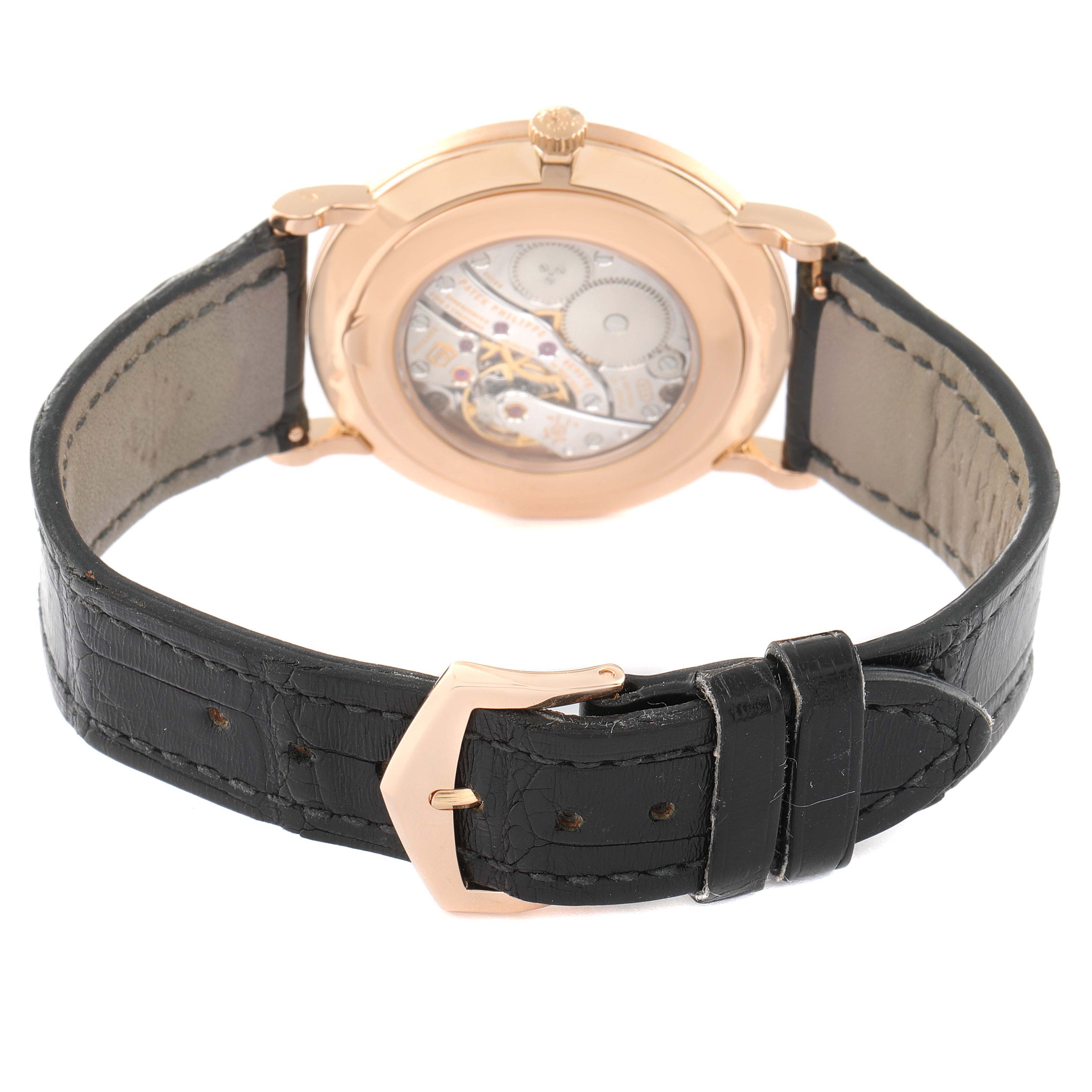 This image shows the back and strap of a Patek Philippe Calatrava 5119R Men's Rose Gold White Dial 5119R Men's Rose Gold White Dial watch, highlighting its movement and black leather strap.