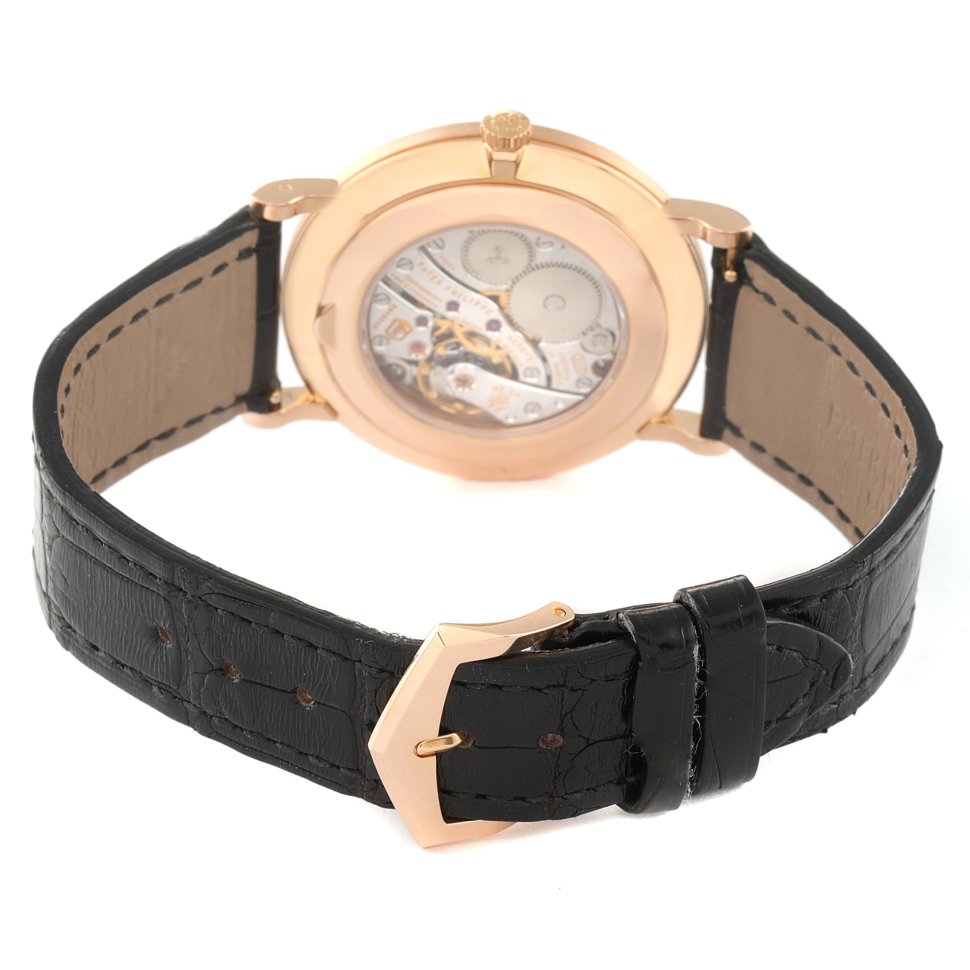 The image shows the backside and strap of a Patek Philippe Calatrava 5119R Men's Rose Gold White Dial 5119R Men's Rose Gold White Dial watch, highlighting the mechanical movement and black leather strap.