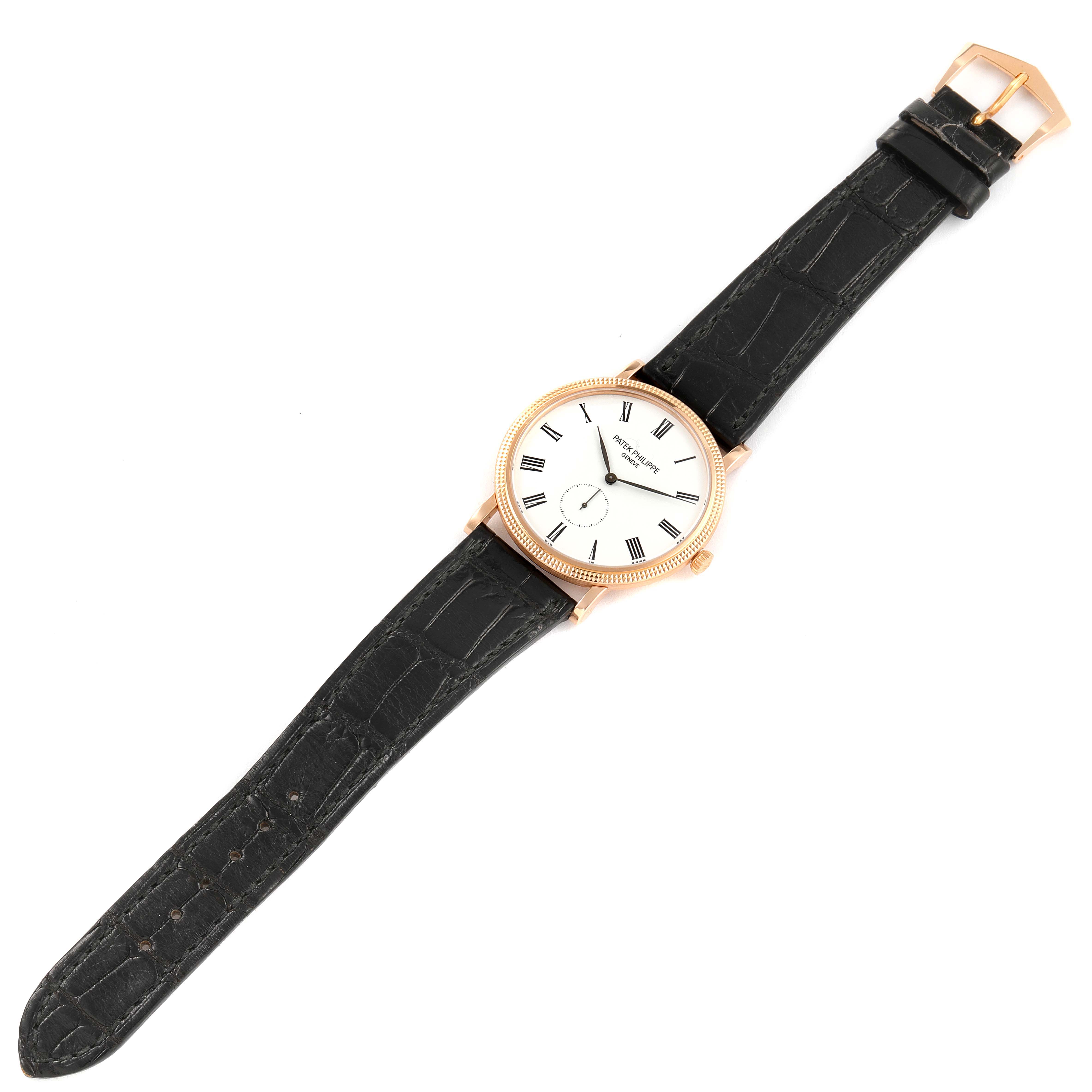This image shows a full view of a Patek Philippe Calatrava 5119R Men's Rose Gold White Dial 5119R Men's Rose Gold White Dial watch with a black leather strap and a white dial.