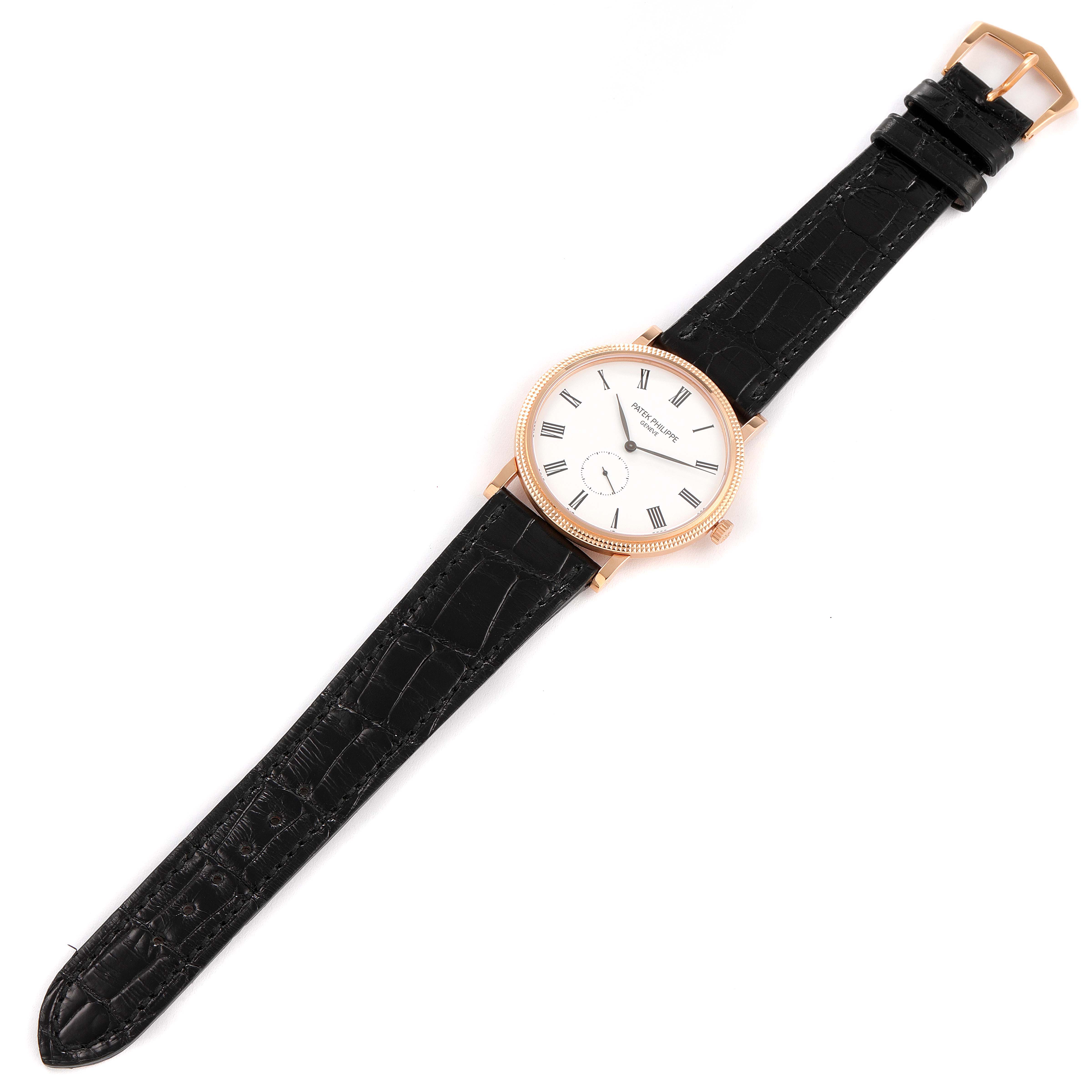 This image shows a top-down view of a Patek Philippe Calatrava 5119R Men's Rose Gold White Dial 5119R Men's Rose Gold White Dial watch with a black leather strap and a white dial.