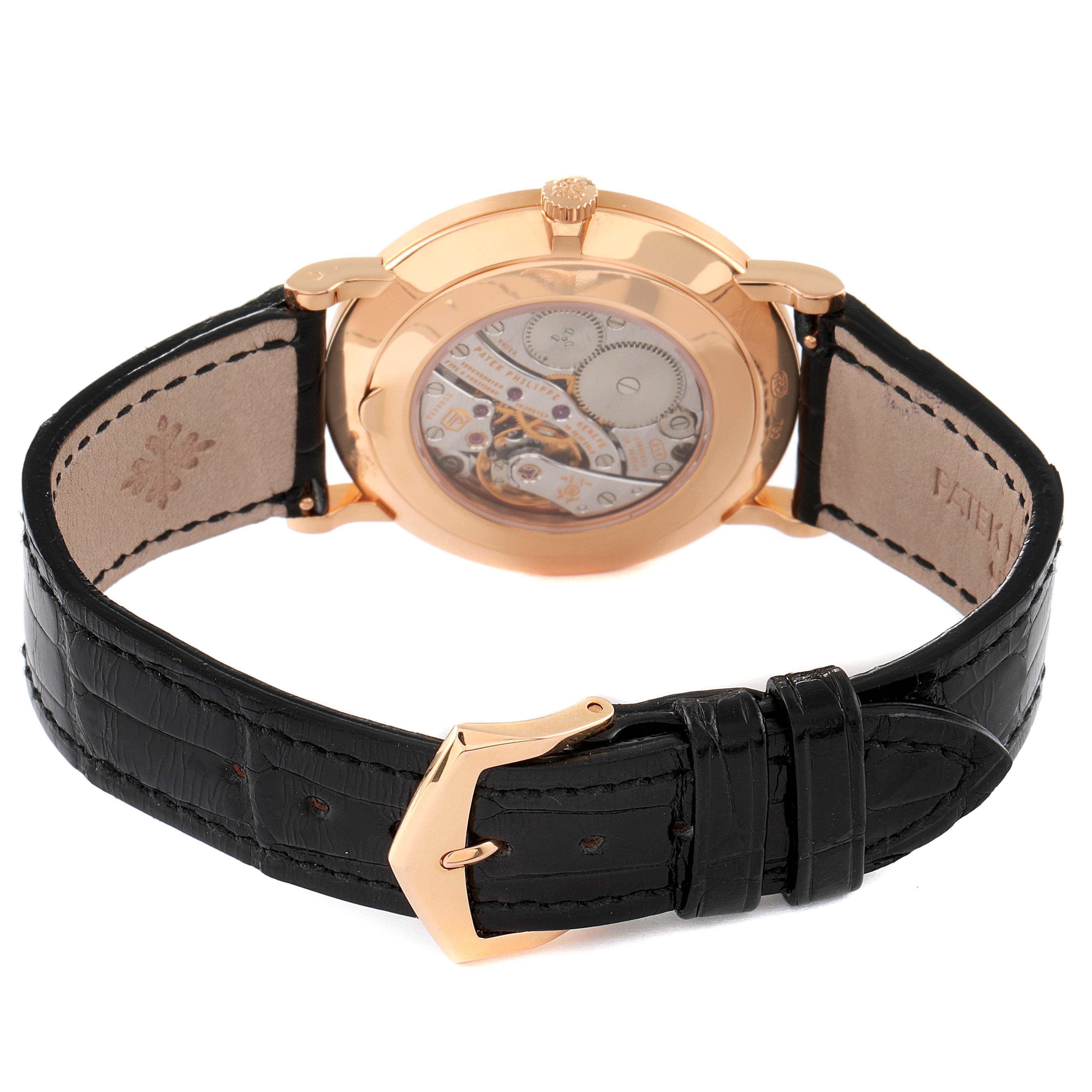 The image shows the back view of a Patek Philippe Calatrava 5119R Men's Rose Gold White Dial 5119R Men's Rose Gold White Dial watch, highlighting the movement and the black leather strap with a gold buckle.