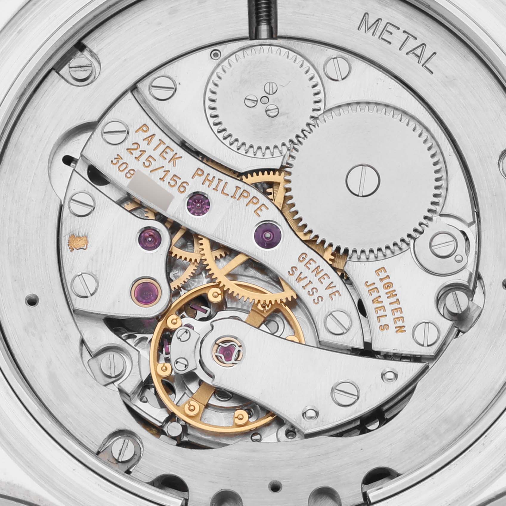 The image shows the movement mechanism of a Patek Philippe Calatrava 5134G Men's White Gold White Dial 5134G Men's White Gold White Dial watch, highlighting gears and inscriptions.