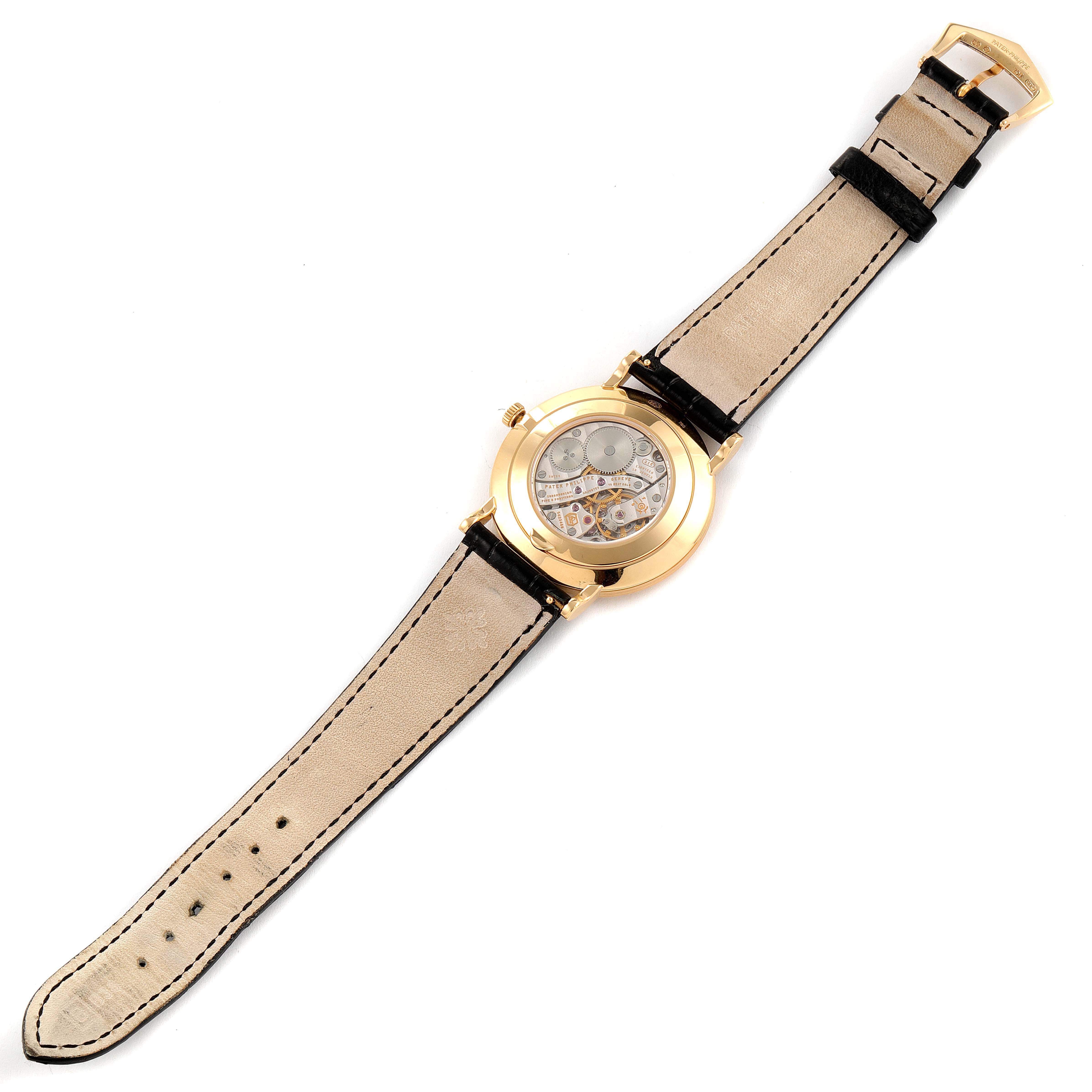 This Patek Philippe Calatrava 5119J Men's Yellow Gold White Dial 5119J Men's Yellow Gold White Dial watch is shown from the back, displaying the open case revealing the mechanical movement.