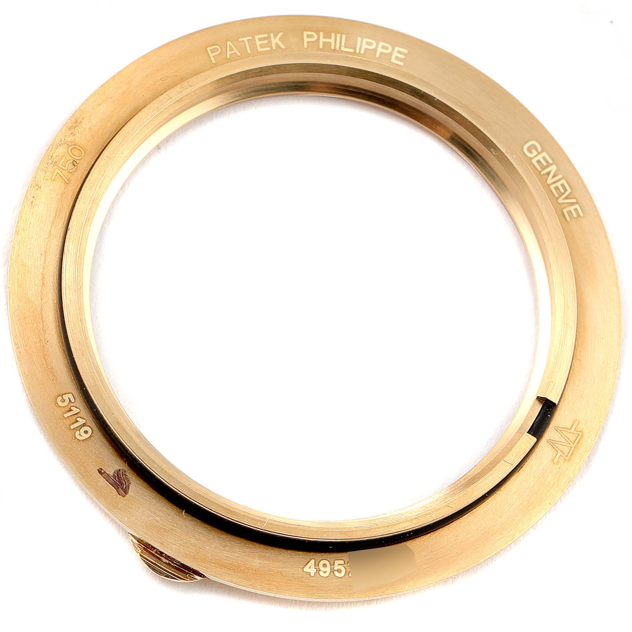 The image shows the bezel of a Patek Philippe Calatrava 5119J Men's Yellow Gold White Dial 5119J Men's Yellow Gold White Dial model watch in gold, viewed from above.