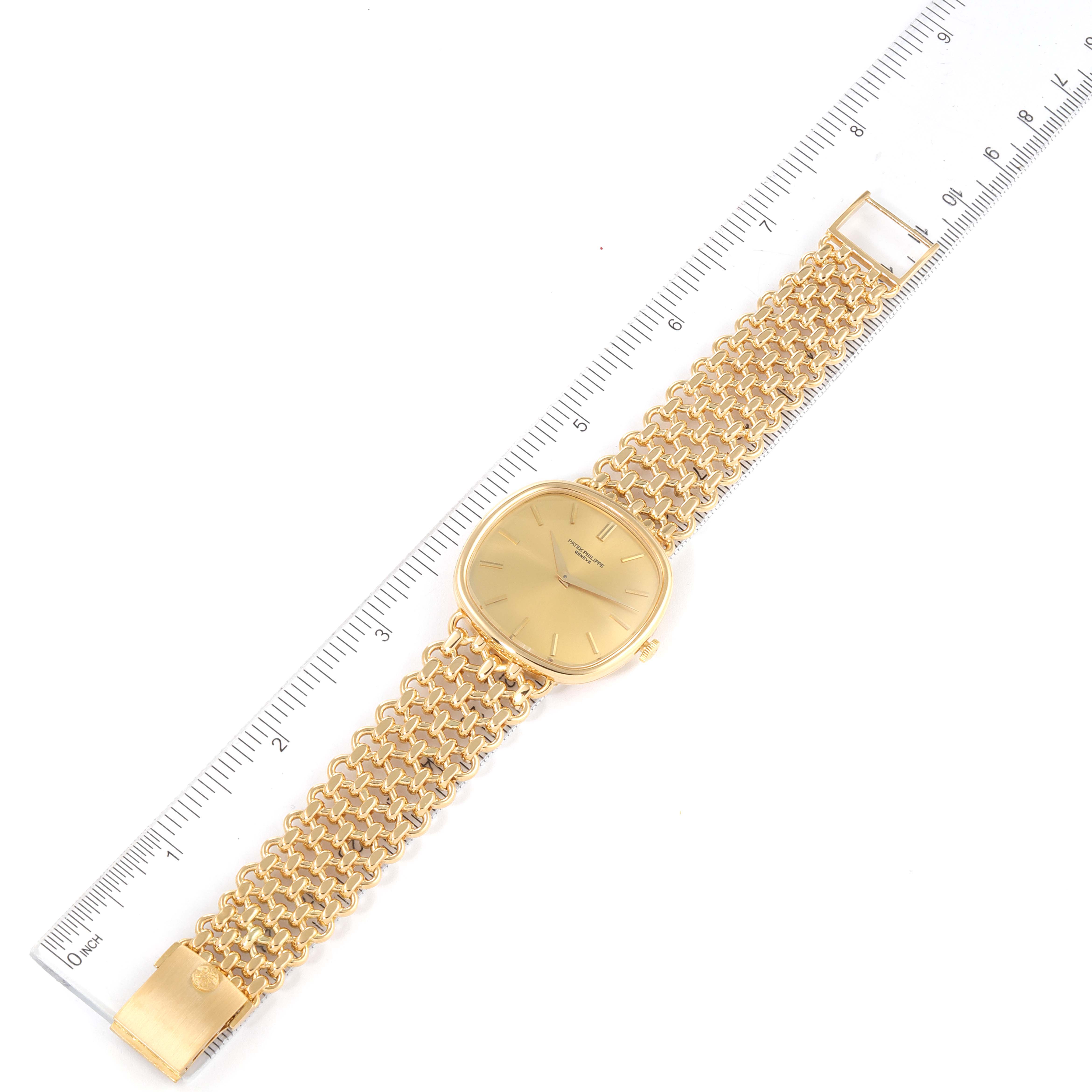 The image shows a top-down view of the Patek Philippe Golden Ellipse 3644 Men's Yellow Gold Champagne Dial 3644 Men's Yellow Gold Champagne Dial watch placed beside a ruler.