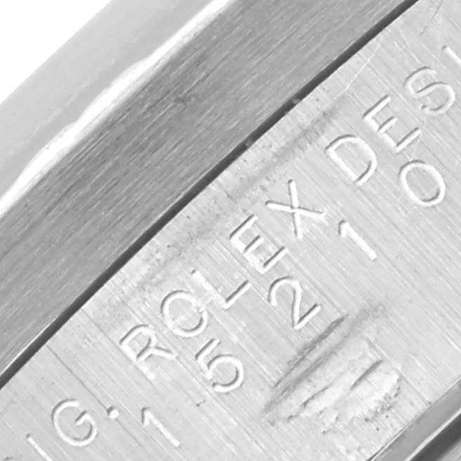 The image shows a close-up of the side engraving on a Rolex Date 15210 Men's Stainless Steel Blue Dial 15210 Men's Stainless Steel Blue Dial model watch case.