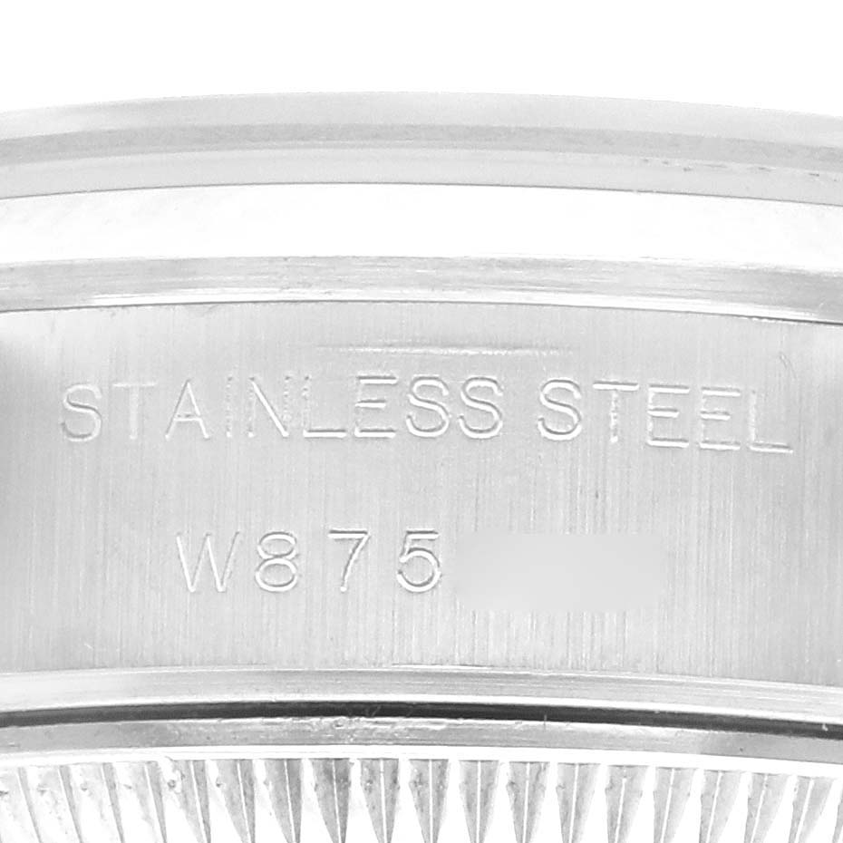 The image shows the side of a Rolex Date 69160 Women's Stainless Steel Blue Dial 69160 Women's Stainless Steel Blue Dial watch case with "STAINLESS STEEL" engraving.