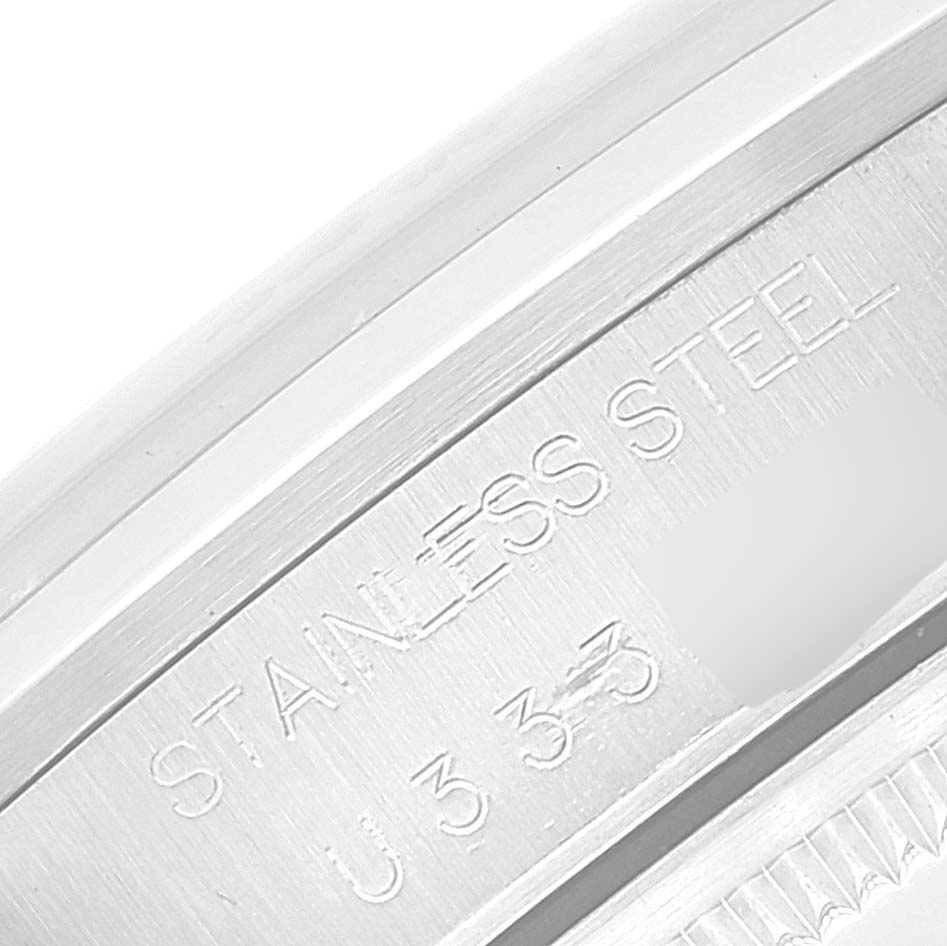 This close-up image shows the engraved details of the stainless steel casing of a Rolex Date 15200 Men's Stainless Steel Silver Dial 15200 Men's Stainless Steel Silver Dial model watch.