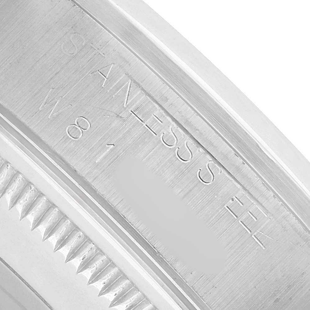 The image shows a close-up of the inner case engraving and fluted bezel of a Rolex Date 15200 Men's Stainless Steel Silver Dial watch emphasizing details.