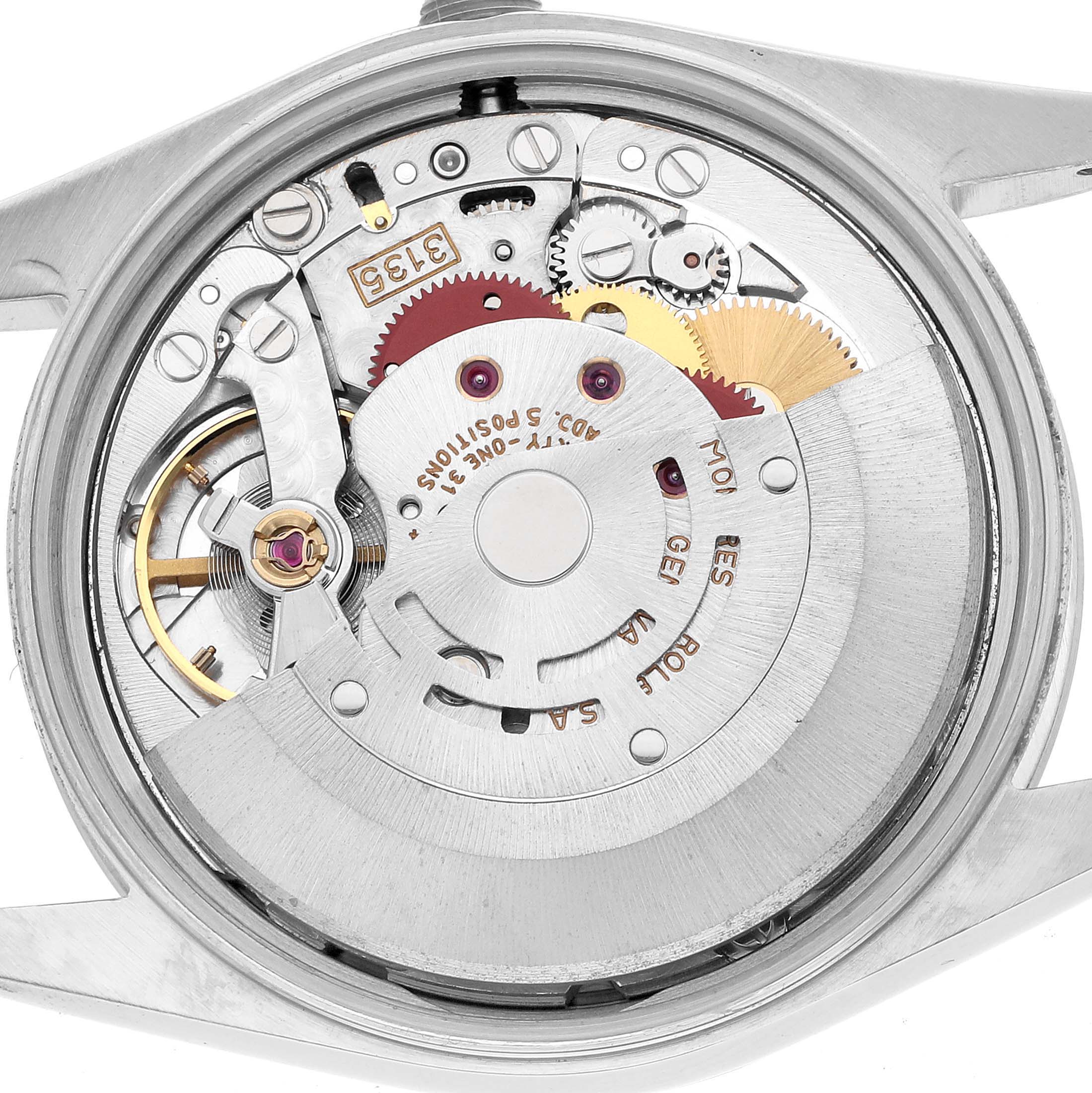 The image shows the movement of a Rolex Date 15200 Men's Stainless Steel Silver Dial watch from a top-down angle, displaying gears and components.