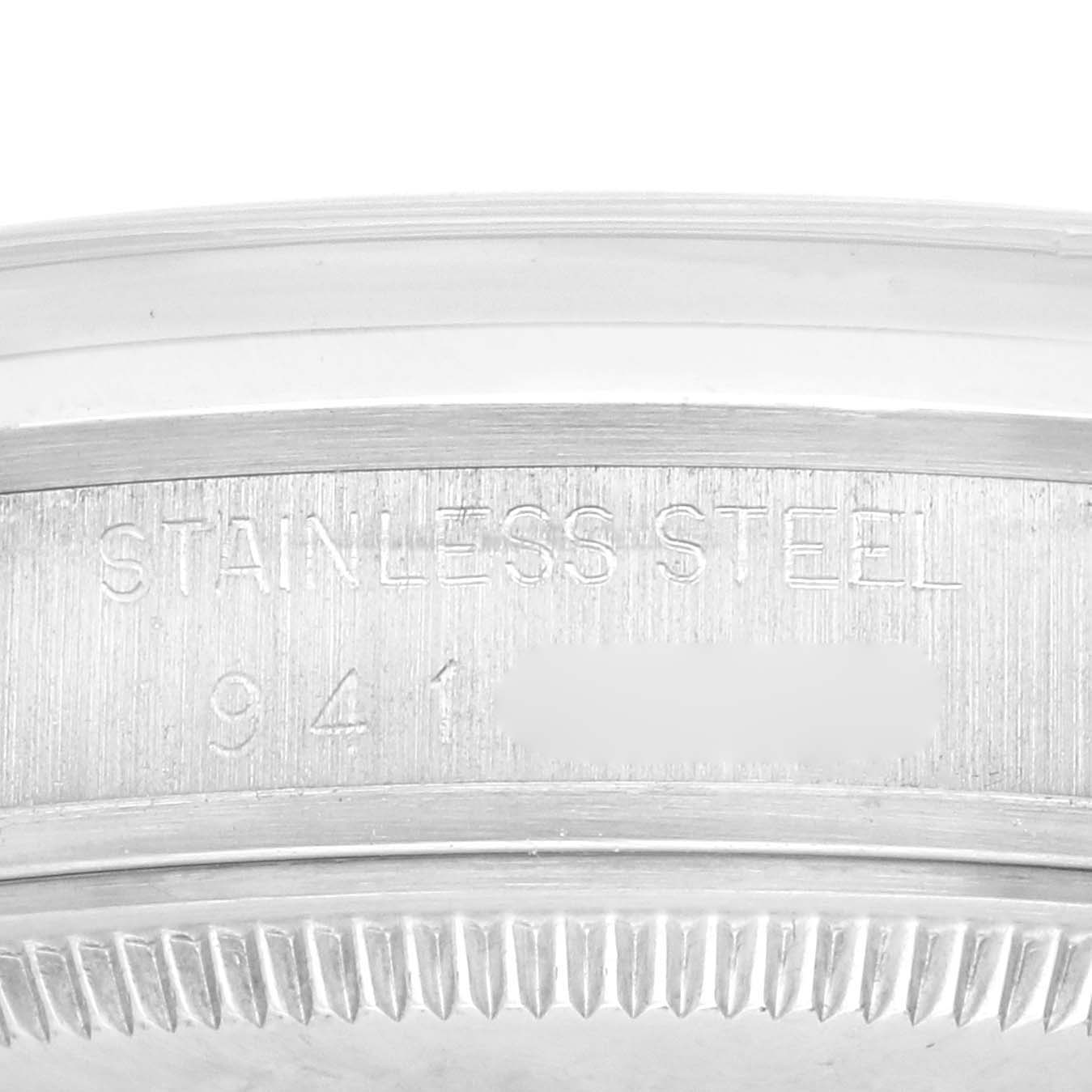 The image shows a close-up of the band and engraved details on the side of the Rolex Date 15000 Men's Stainless Steel Silver Dial 15000 Men's Stainless Steel Silver Dial model watch case.