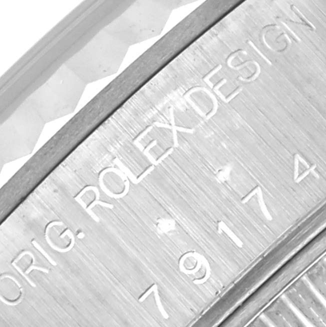 The image shows a close-up of the serial number engraving on a Rolex Datejust 79174 Women's Stainless Steel Silver Dial 79174 Women's Stainless Steel Silver Dial watch case.