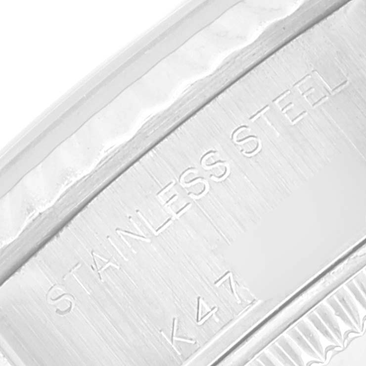The image shows a close-up of the side engraving on a Rolex Datejust 79174 Women's Stainless Steel Silver Dial 79174 Women's Stainless Steel Silver Dial, indicating "STAINLESS STEEL" and a serial/code.