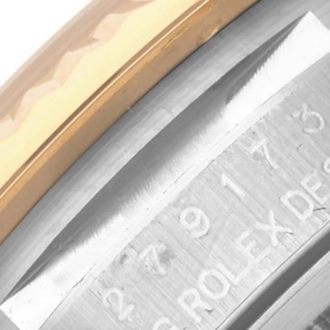 This image shows a close-up of the side of a Rolex Datejust 279173 Women's Steel and Gold (two tone) Champagne Dial 279173 Women's Steel and Gold (two tone) Champagne Dial watch, highlighting the bezel and engraved serial details.