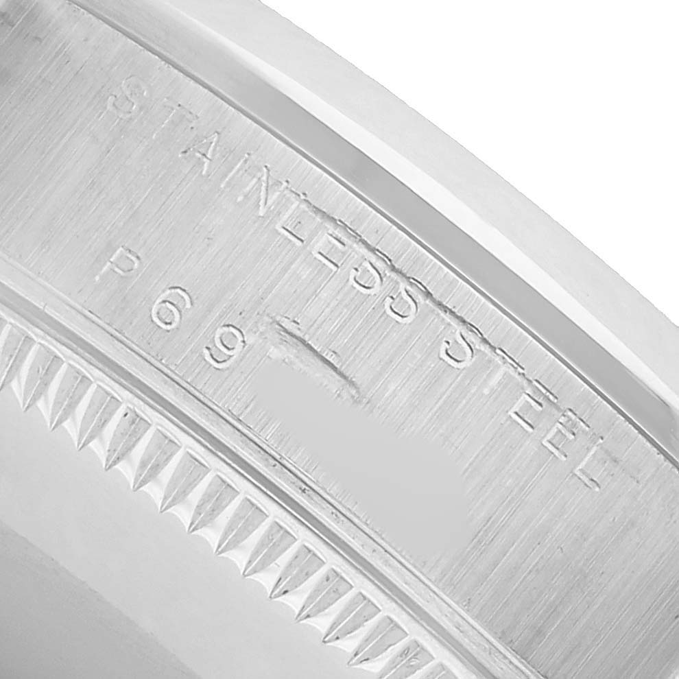The image shows a close-up angle of the side of a Rolex Datejust 78240 Women's Stainless Steel Pink Dial, focusing on the stainless steel engravings on the bezel.