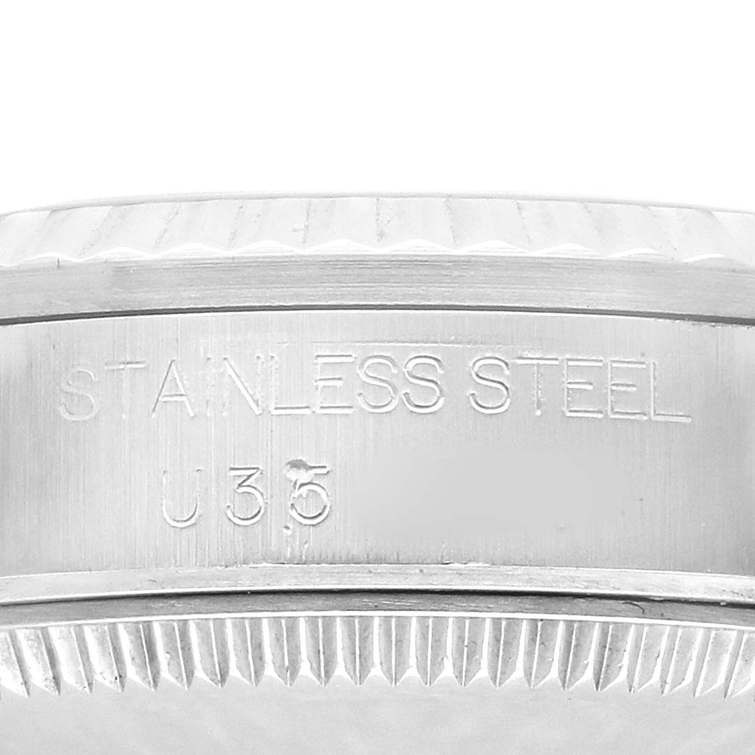 The image shows a side view of the Rolex Datejust 68274 Women's Stainless Steel Silver Dial's stainless steel case with engraved text.