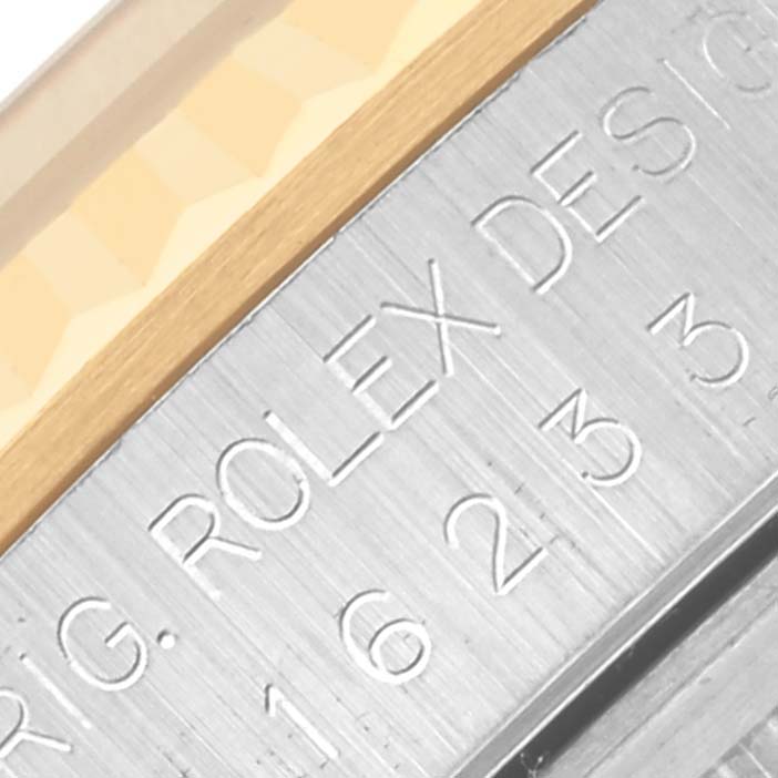 The image shows a close-up of the case engravings on the Rolex Datejust 16233 Men's Steel and Gold (two tone) Black Dial 16233 Men's Steel and Gold (two tone) Black Dial watch.