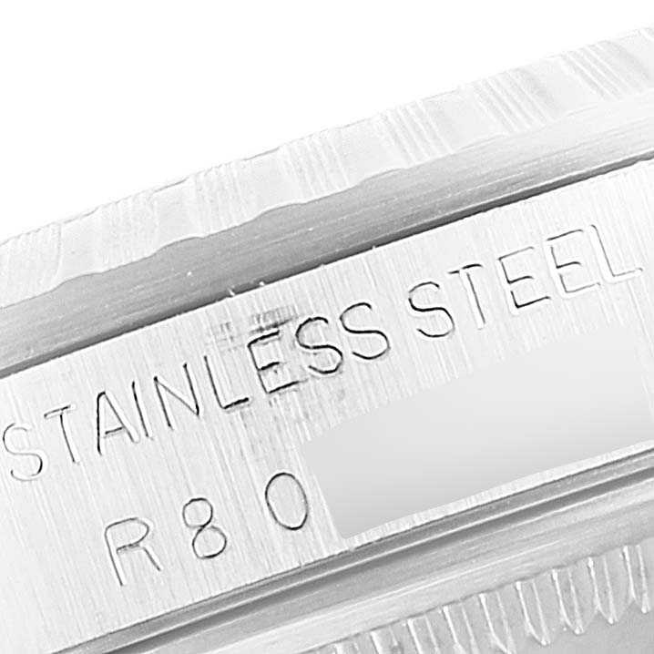 This close-up shows part of the stainless steel casing of a Rolex Datejust 16220 Men
s Stainless Steel Blue Dial 16220 Men
s Stainless Steel Blue Dial watch.