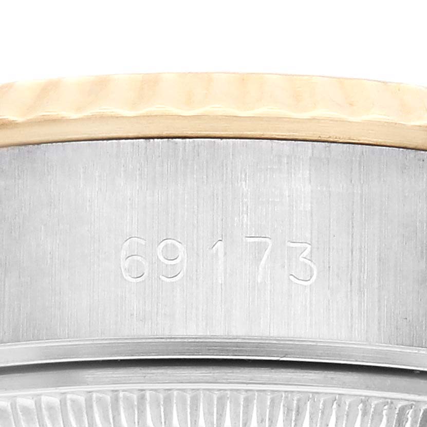 The image shows a side view of the Rolex Datejust 69173 Women's Steel and Gold (two tone) Champagne Dial 69173 Women's Steel and Gold (two tone) Champagne Dial model, highlighting the serial number on its metal casing.