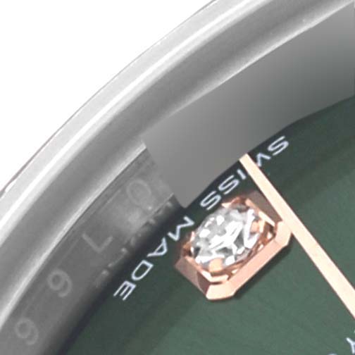 The image shows a close-up of the Rolex Datejust 279381RBR Women's Steel and Gold (two tone) Green Dial 279381RBR Women's Steel and Gold (two tone) Green Dial, focusing on a portion of the dial with a diamond marker and text.