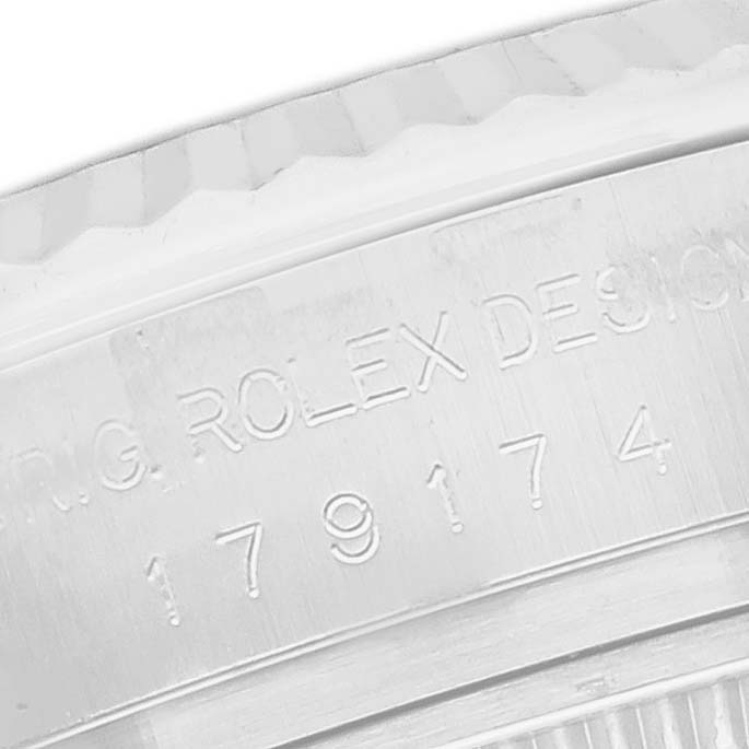 The image shows an engraving on the inner bezel of a Rolex Datejust 179174 Women's Stainless Steel Mother of Pearl Dial watch, detailing the model name and design number.