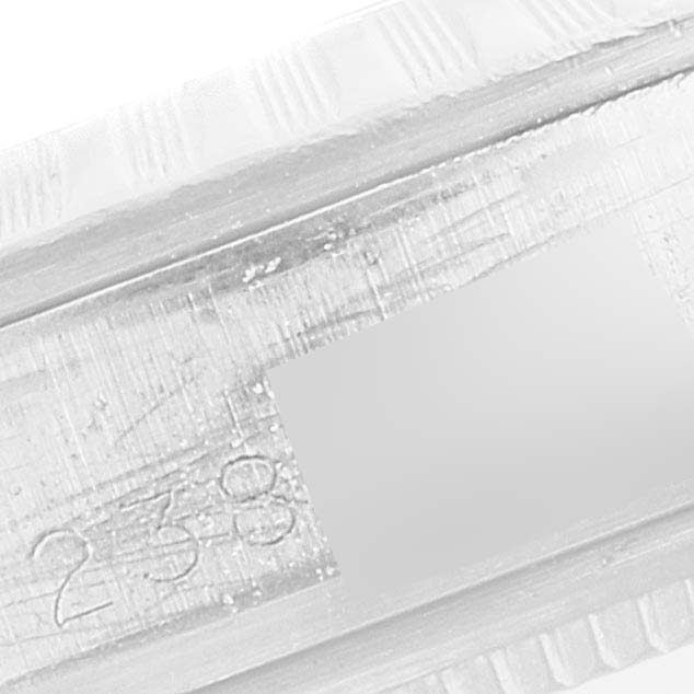 This image shows a close-up of the engraved serial number on the side of a Vintage Collection watch by Rolex.