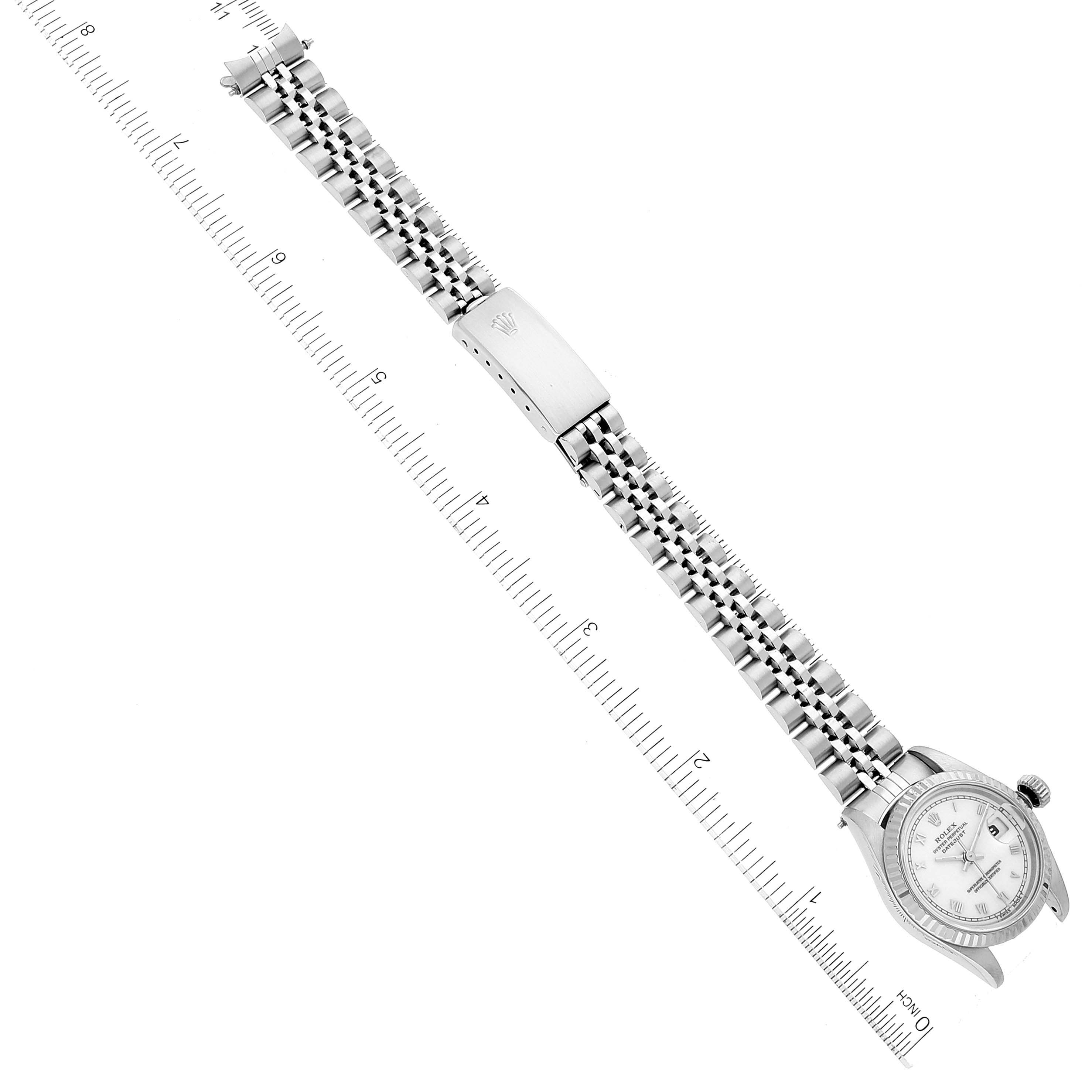 The image shows a top-down view of a Rolex Datejust 69174 Women's Stainless Steel White Dial 69174 Women's Stainless Steel White Dial watch, including its full band and clasp.