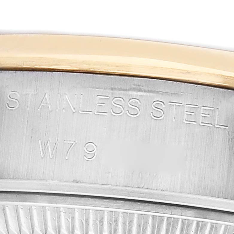 The image shows the side engraving on the bezel of a Rolex Datejust 69163 Women's Steel and Gold (two tone) Black Dial watch, highlighting the stainless steel and gold details.