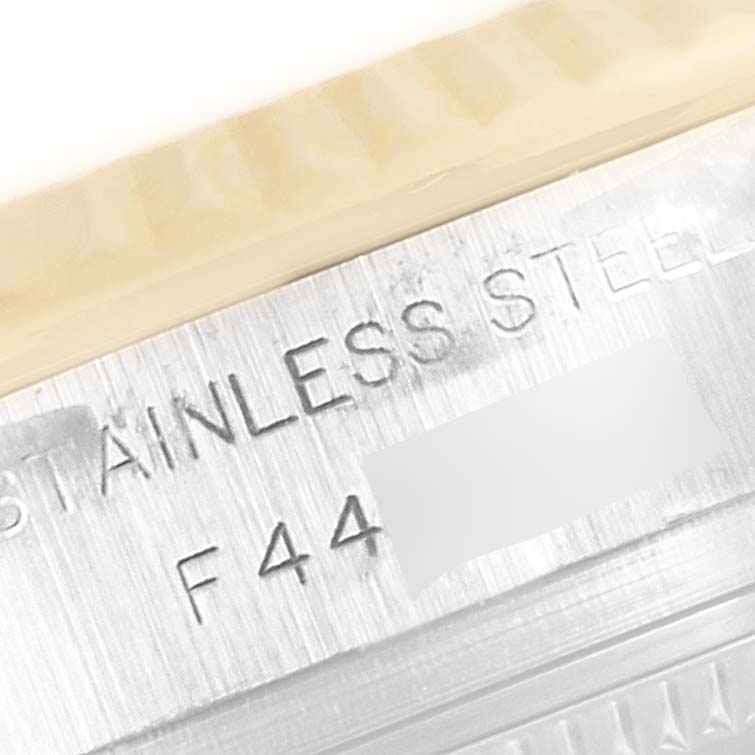 The image shows a close-up angle of the stainless steel case back of a Rolex Datejust 179173 Women
s Steel and Gold (two tone) Silver Dial 179173 Women
s Steel and Gold (two tone) Silver Dial watch.