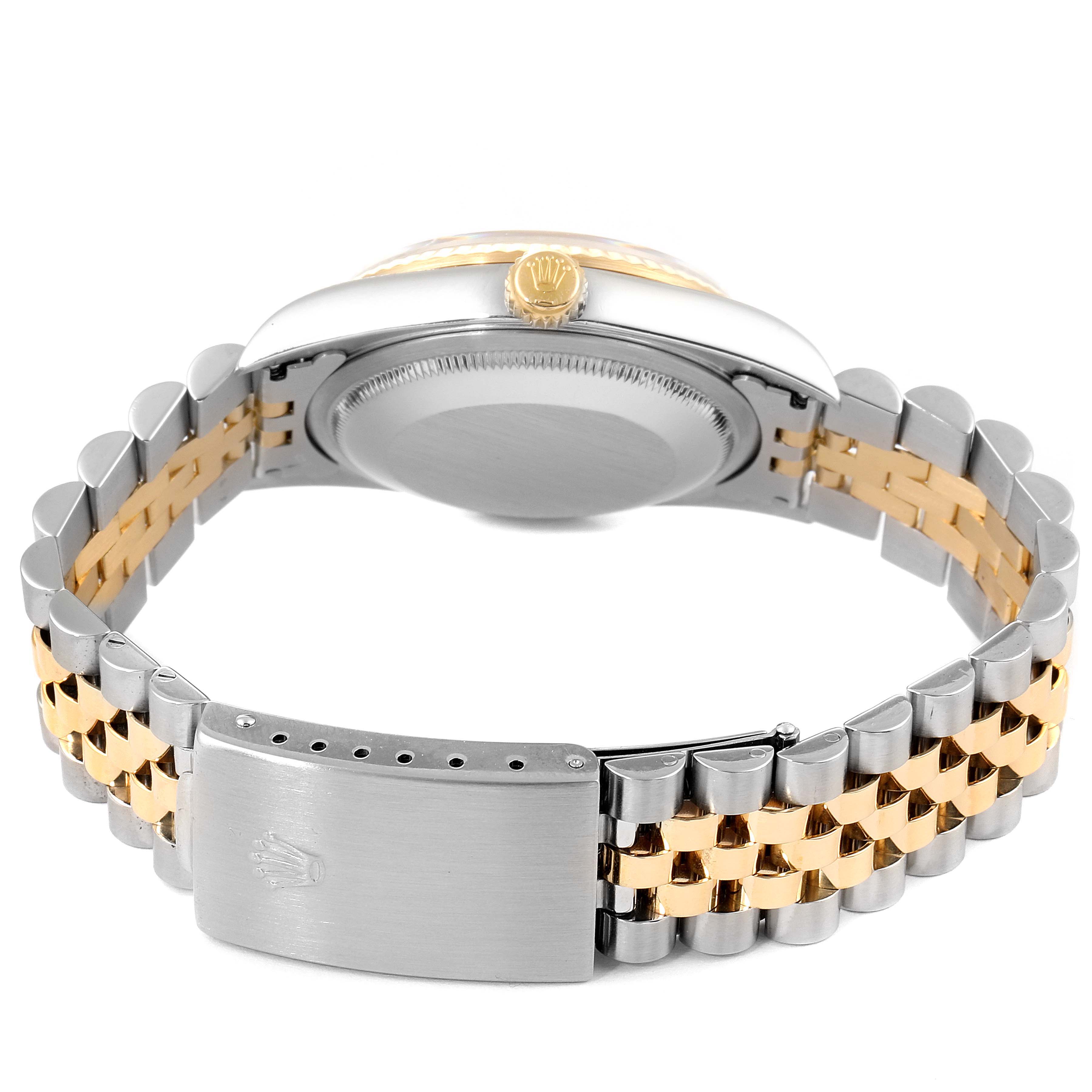 The image shows a Rolex Datejust 16233 Men
s Steel and Gold (two tone) Mother of Pearl Dial 16233 Men
s Steel and Gold (two tone) Mother of Pearl Dial watch from the back, highlighting the clasp, bracelet, and side crown.