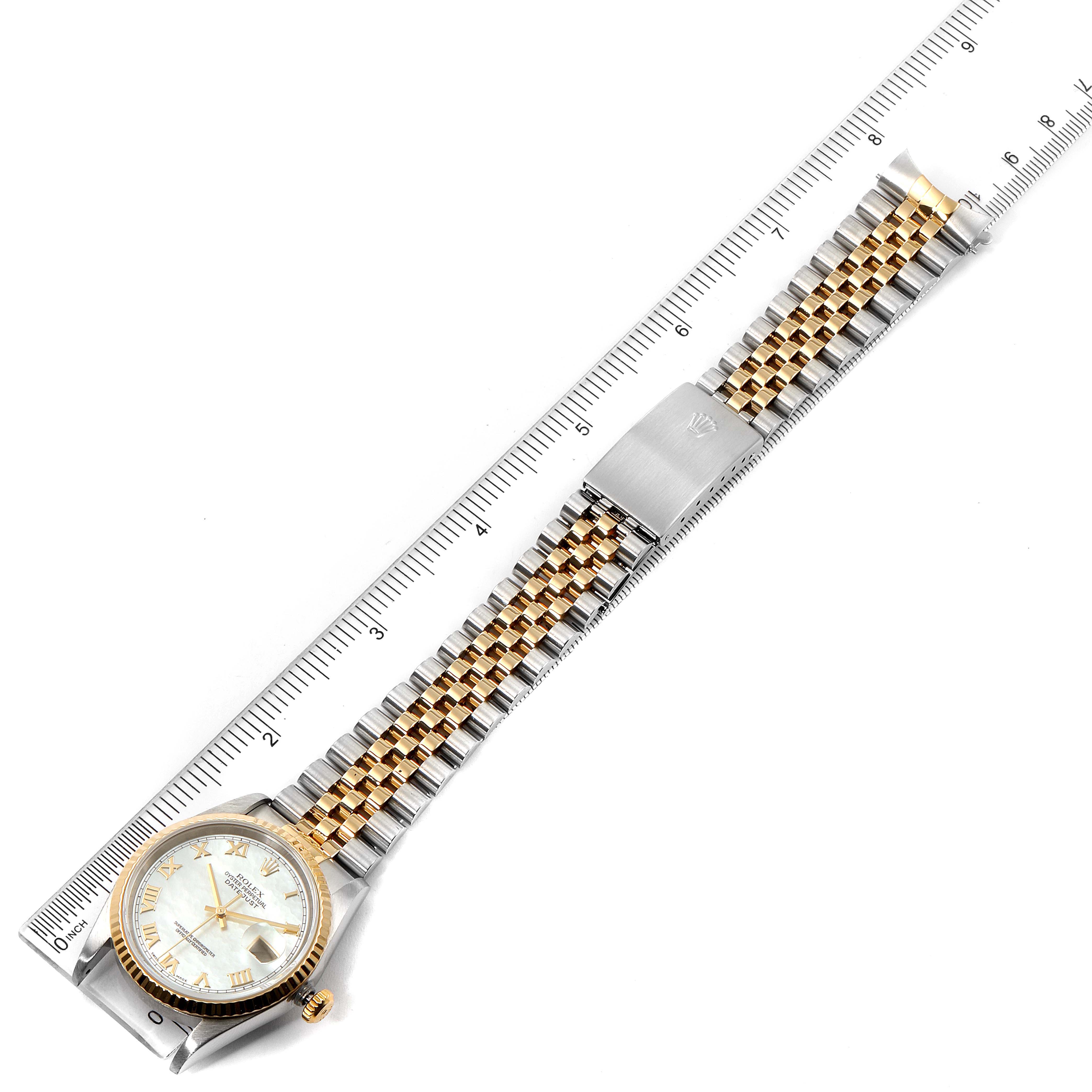 The image shows a Rolex Datejust 16233 Men
s Steel and Gold (two tone) Mother of Pearl Dial 16233 Men
s Steel and Gold (two tone) Mother of Pearl Dial watch laid flat with a ruler measuring its length, highlighting the face, bezel, and bracelet.