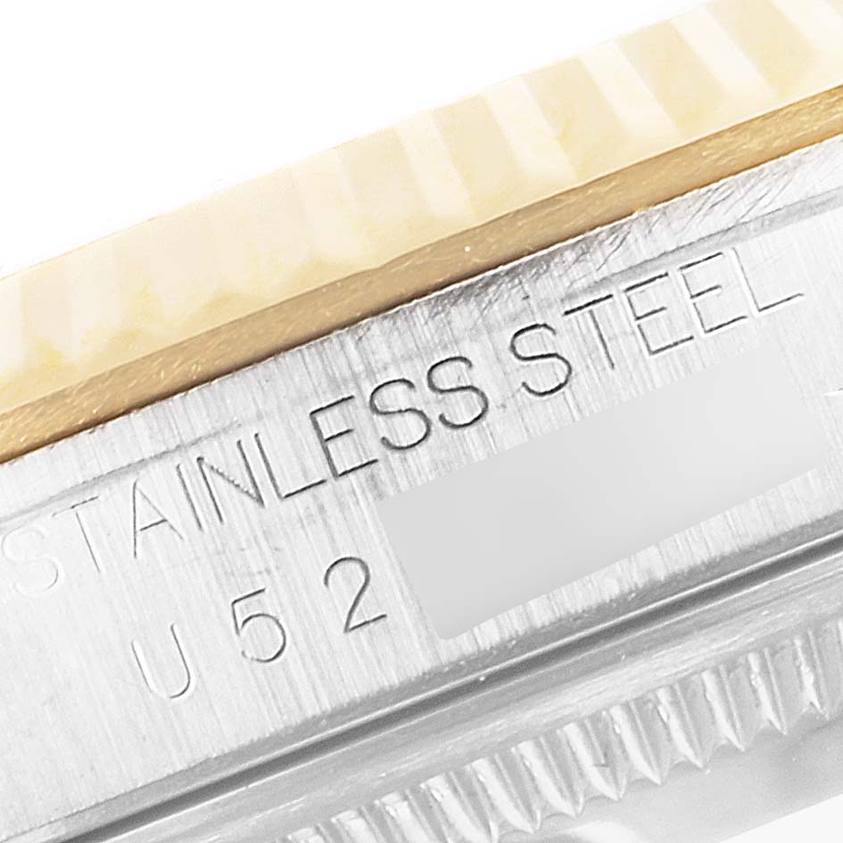 This close-up image shows the side of a Rolex Datejust 16233 Men's Steel and Gold (two tone) Blue Dial 16233 Men's Steel and Gold (two tone) Blue Dial, highlighting the stainless steel material and the grooved bezel.