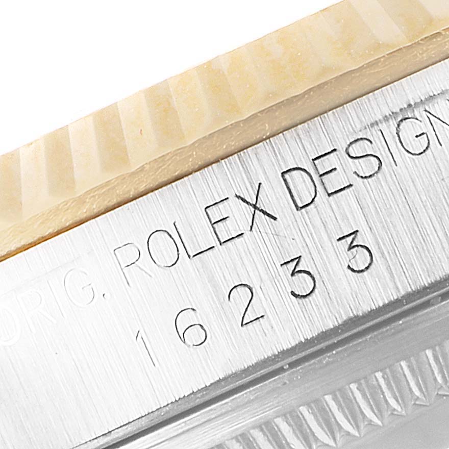 This is a close-up of the bezel and engraved serial number of the Rolex Datejust 16233 Men's Steel and Gold (two tone) Blue Dial 16233 Men's Steel and Gold (two tone) Blue Dial watch.
