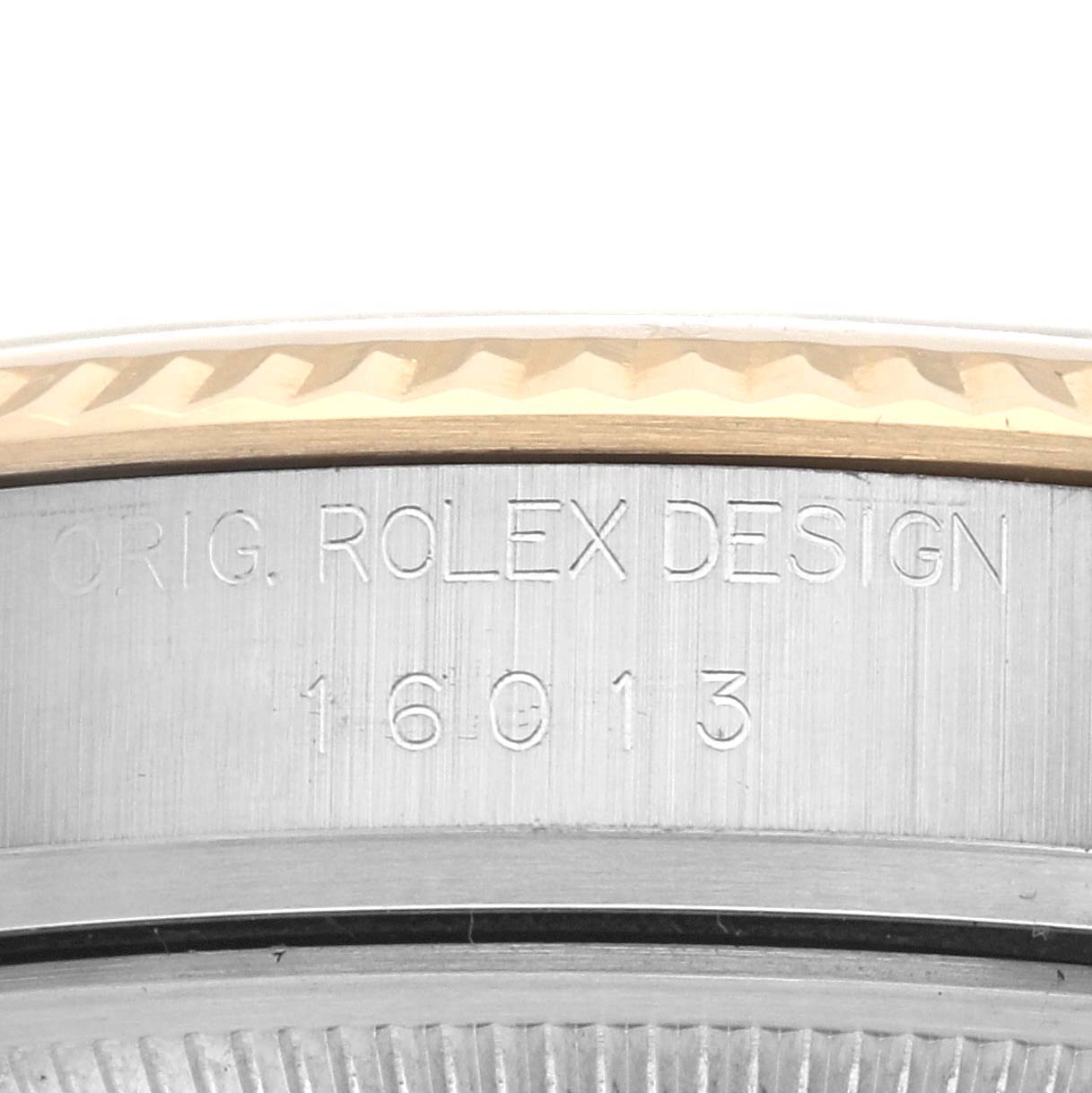 The image shows a close-up of the Rolex Datejust 16013 Men's Steel and Gold (two tone) Champagne Dial 16013 Men's Steel and Gold (two tone) Champagne Dial model's bezel and engraved case details.