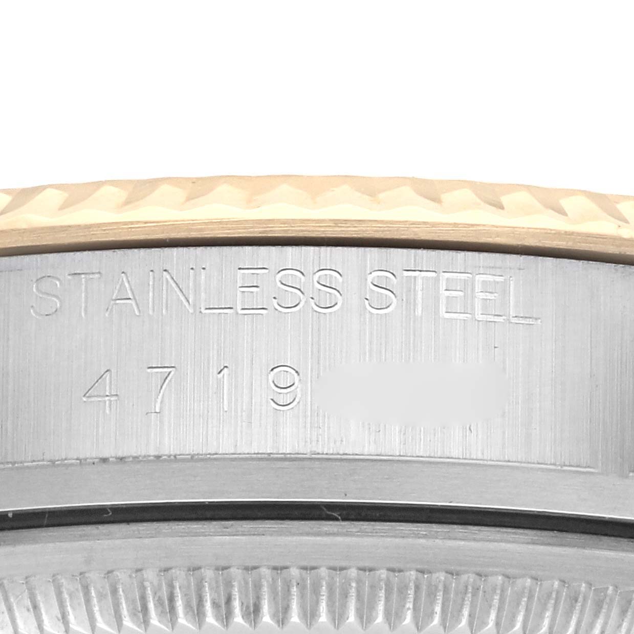 The image shows the side view of a Rolex Datejust 16013 Men's Steel and Gold (two tone) Champagne Dial 16013 Men's Steel and Gold (two tone) Champagne Dial watch, focusing on the engraved stainless steel section.