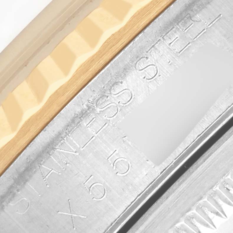 The image shows a close-up of the engraved side of a Rolex Datejust 16233 Men's Steel and Gold (two tone) White Dial 16233 Men's Steel and Gold (two tone) White Dial bezel with stainless steel text.