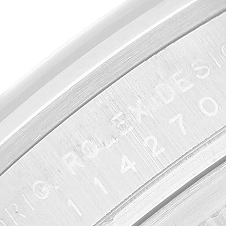 The image shows a close-up of the engraved inscription on the case edge of a Rolex Explorer 114270 Men
s Stainless Steel Black Dial 114270 Men
s Stainless Steel Black Dial watch.