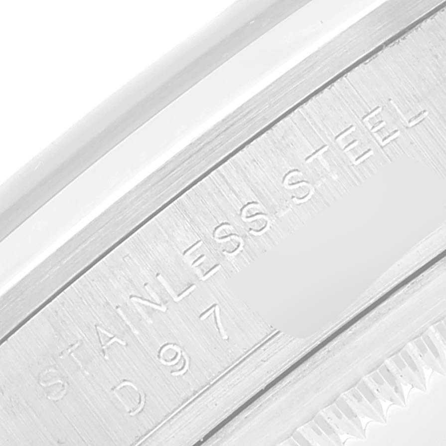 The image shows a close-up of the case back edge of a Rolex Explorer 114270 Men
s Stainless Steel Black Dial 114270 Men
s Stainless Steel Black Dial, highlighting the "STAINLESS STEEL" engraving.