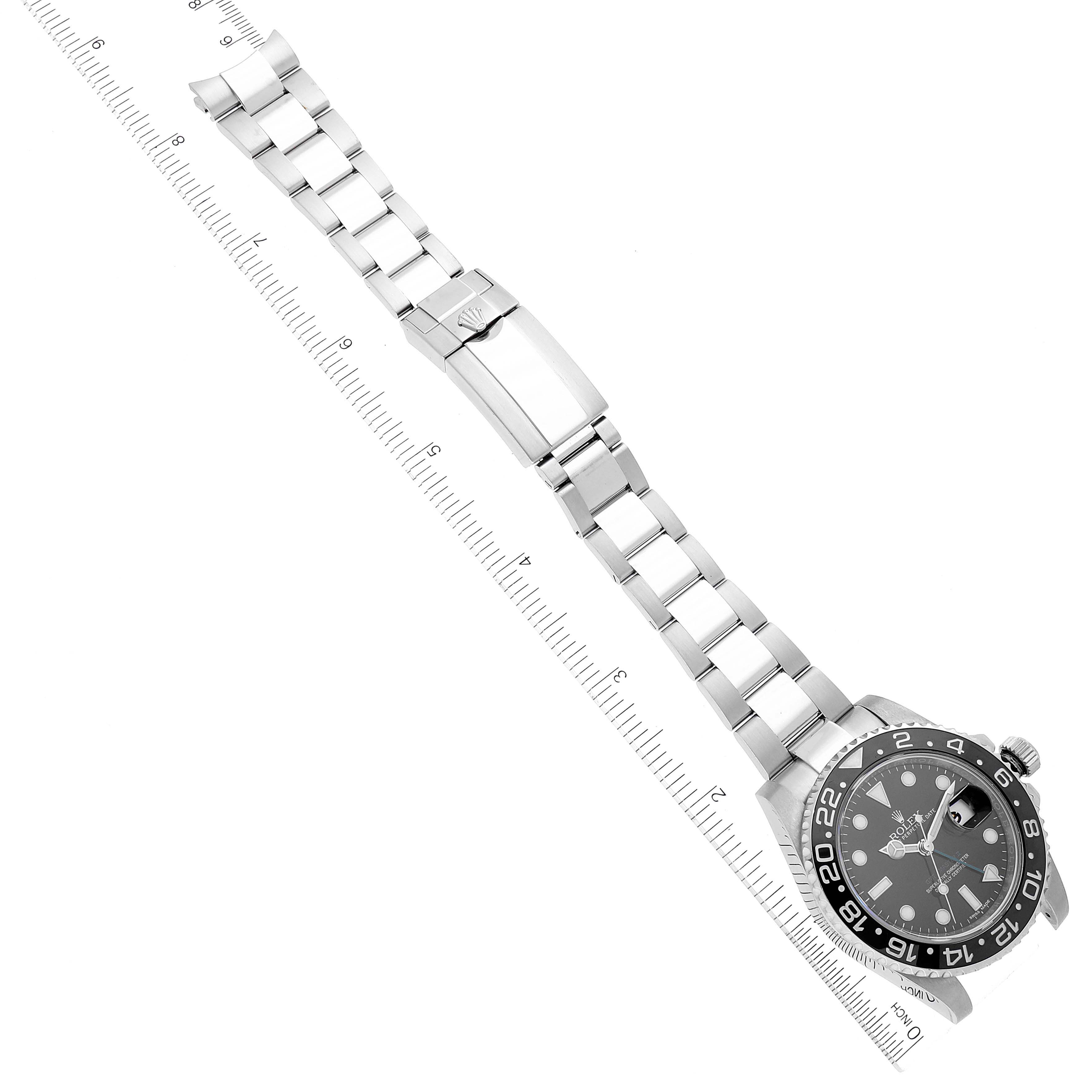 The image shows a top view of a Rolex GMT-Master 116710 Men
s Stainless Steel Black Dial 116710 Men
s Stainless Steel Black Dial watch, highlighting the dial, bezel, bracelet, and clasp, aligned with a ruler.