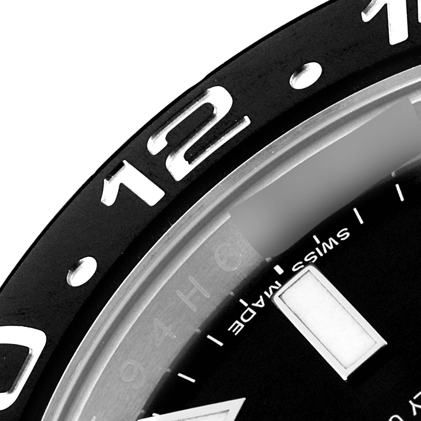 The angle shows a close-up of the bezel and part of the dial of the Rolex GMT-Master 116710 Men
s Stainless Steel Black Dial 116710 Men
s Stainless Steel Black Dial, highlighting the number 12 and "Swiss Made" text.