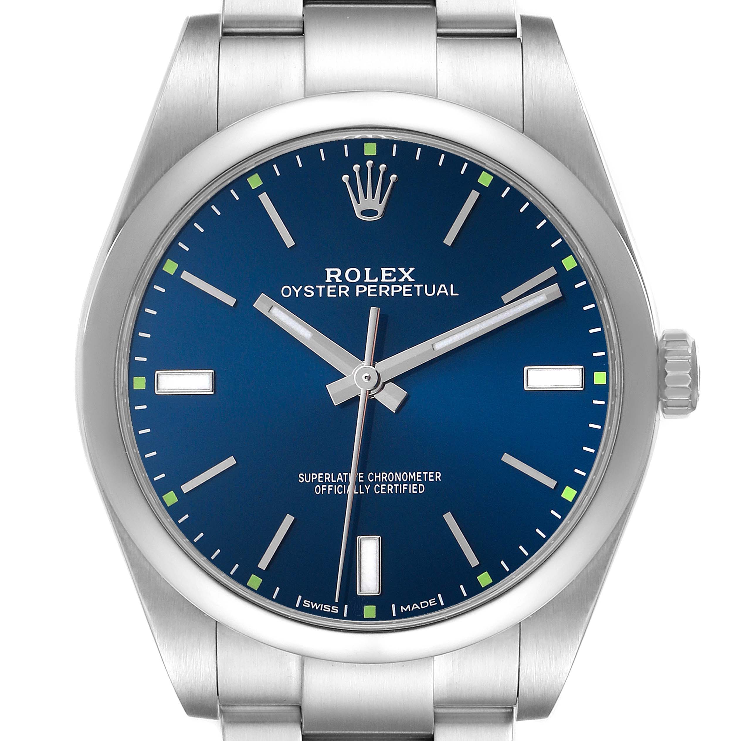 The image shows a front view of a Rolex Oyster Perpetual 114300 Men's Stainless Steel Blue Dial watch, highlighting the blue dial, indices, hands, and part of the bracelet.