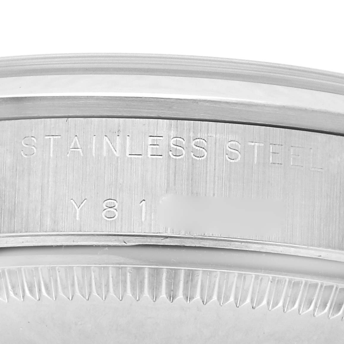 The image shows a close-up of the side and serial number area on a stainless steel Rolex Mid-Size 77080 Women's Stainless Steel Pink Dial 77080 Women's Stainless Steel Pink Dial watch case.