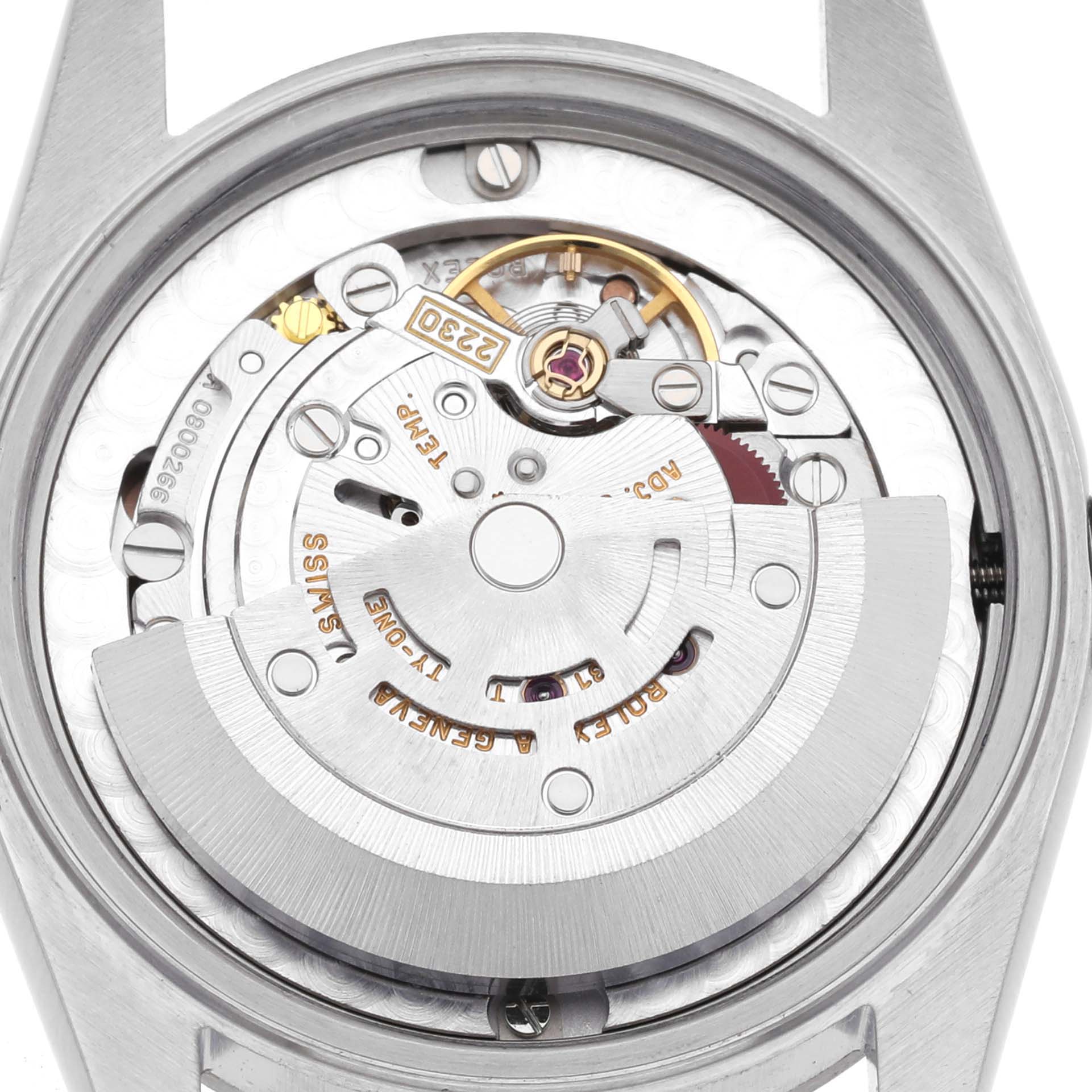 The image shows the interior movement of a Rolex Mid-Size 77080 Women's Stainless Steel Pink Dial 77080 Women's Stainless Steel Pink Dial watch, viewed from the back, highlighting gears and engravings.