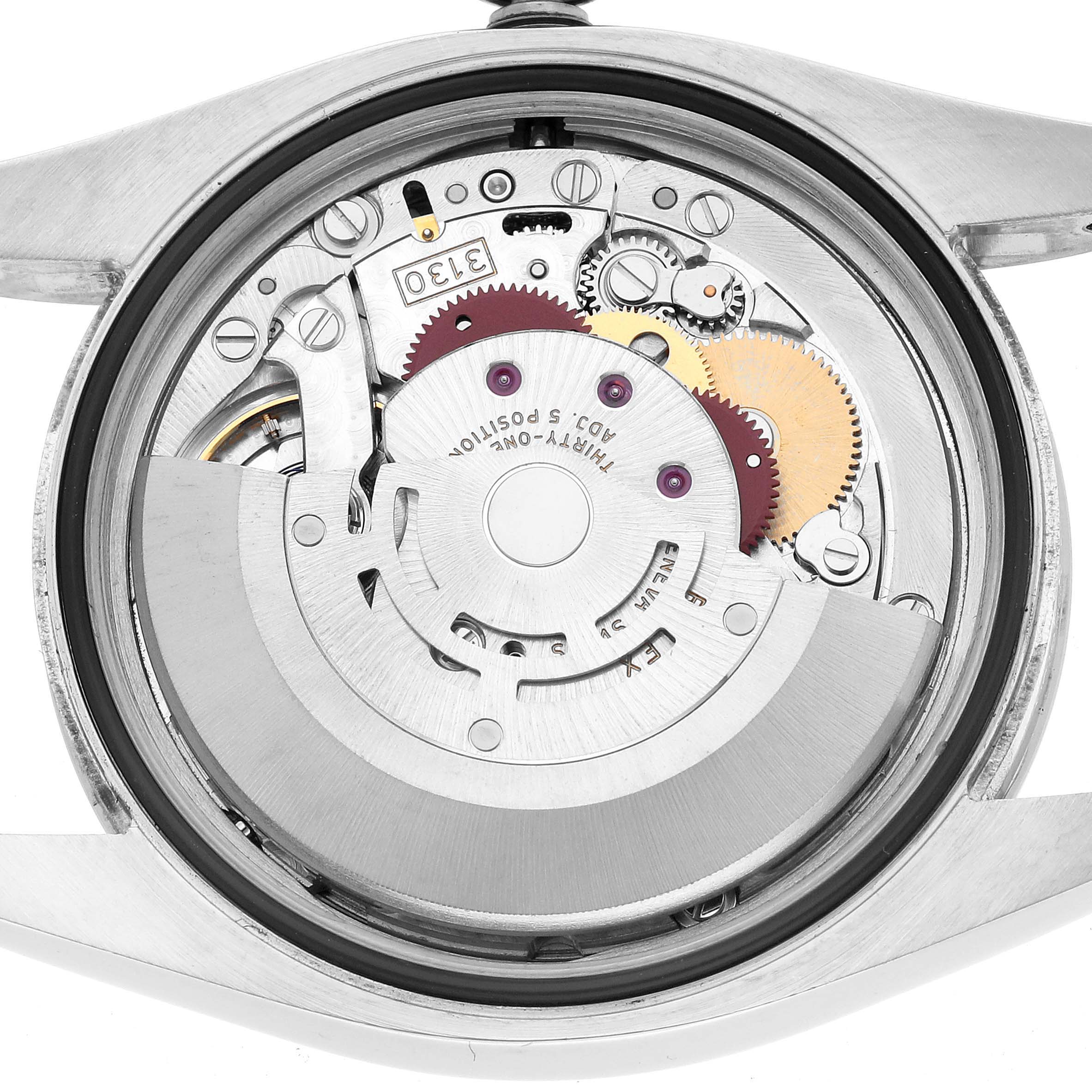 The image shows the back view of a Rolex Oyster Perpetual 116034 Men's Stainless Steel Silver Dial watch movement, highlighting gears and mechanical components.
