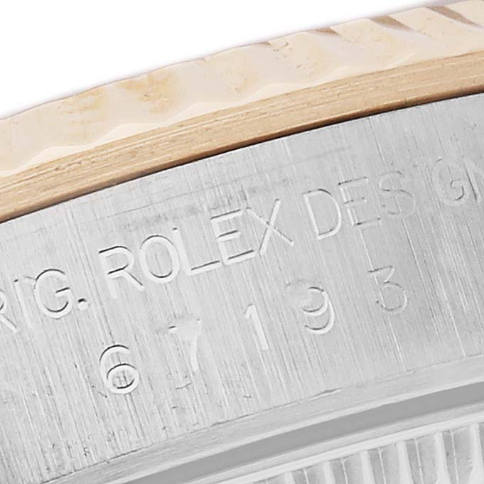 The image shows a close-up of the watch case side and bezel of a Rolex Oyster Perpetual 67193 Women's Steel and Gold (two tone) Champagne Dial 67193 Women's Steel and Gold (two tone) Champagne Dial, highlighting engravings.