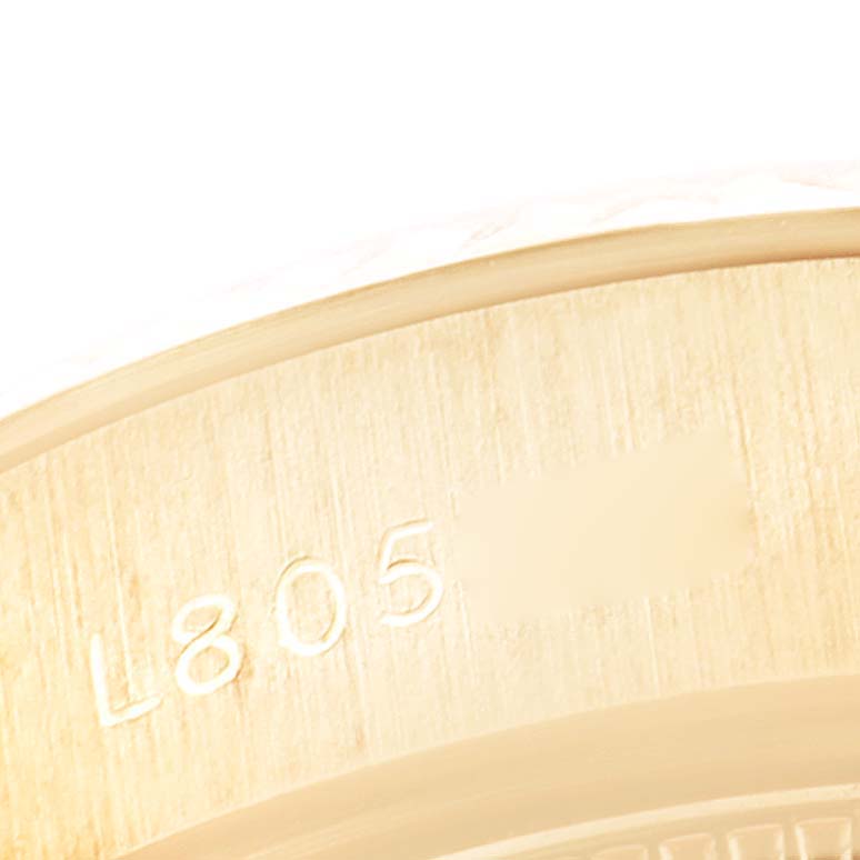 The image shows a close-up of the inner bezel of a Rolex Datejust 69178 Women's Yellow Gold Champagne Dial 69178 Women's Yellow Gold Champagne Dial watch, highlighting the serial number engraving.