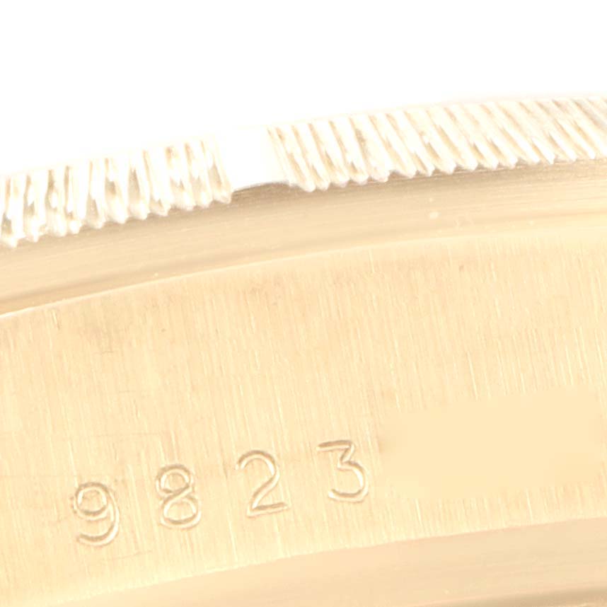 This image shows a close-up of the serial number and fluted bezel of the Rolex President 18078 Men's Yellow Gold Champagne Dial 18078 Men's Yellow Gold Champagne Dial model watch.