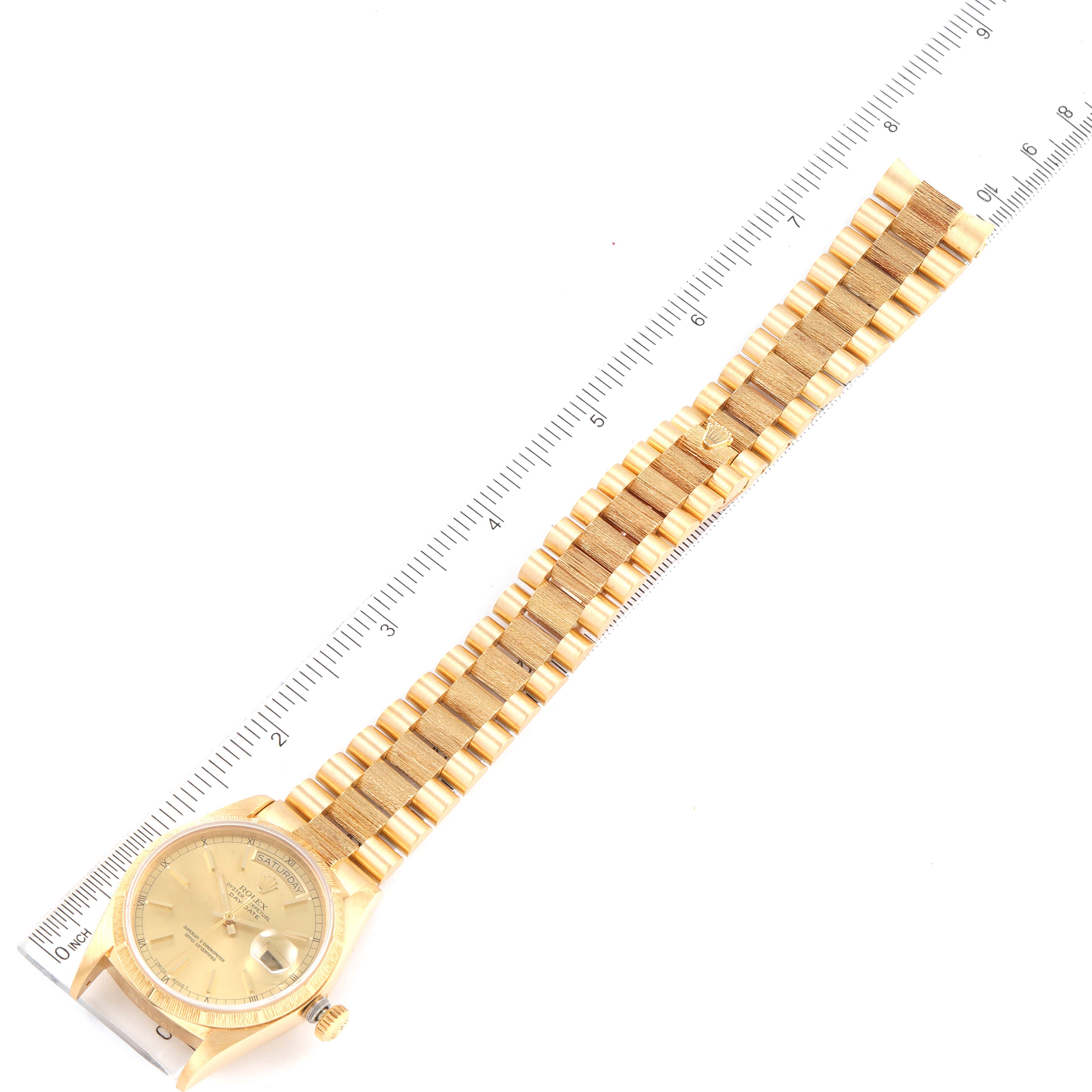 The Rolex President 18078 Men's Yellow Gold Champagne Dial 18078 Men's Yellow Gold Champagne Dial model watch is shown laid flat, displaying the face, crown, and full bracelet against a ruler for scale.