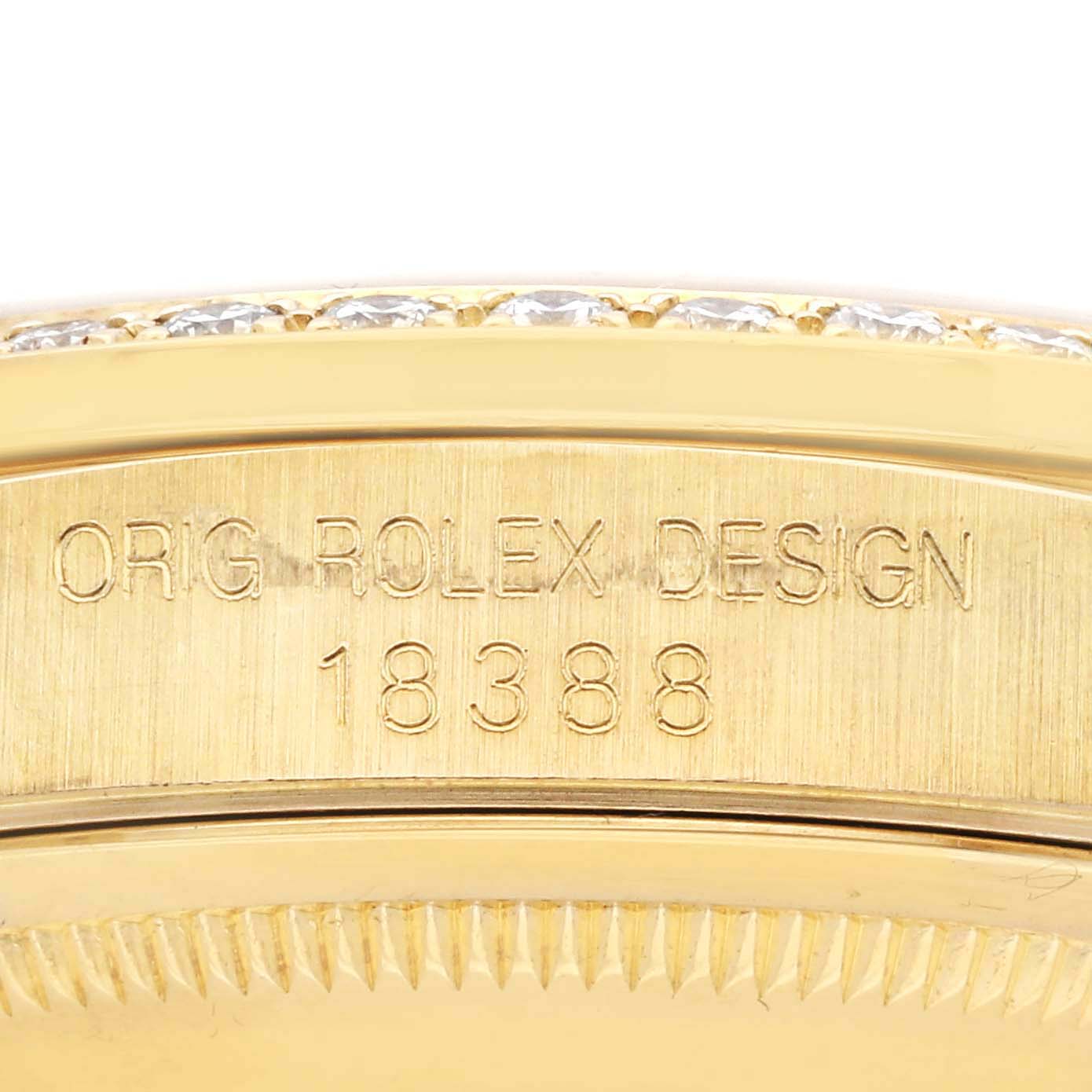 The image shows a close-up of the side case with engravings on the Rolex President 18388 Men's Yellow Gold Grey Dial 18388 Men's Yellow Gold Grey Dial model.