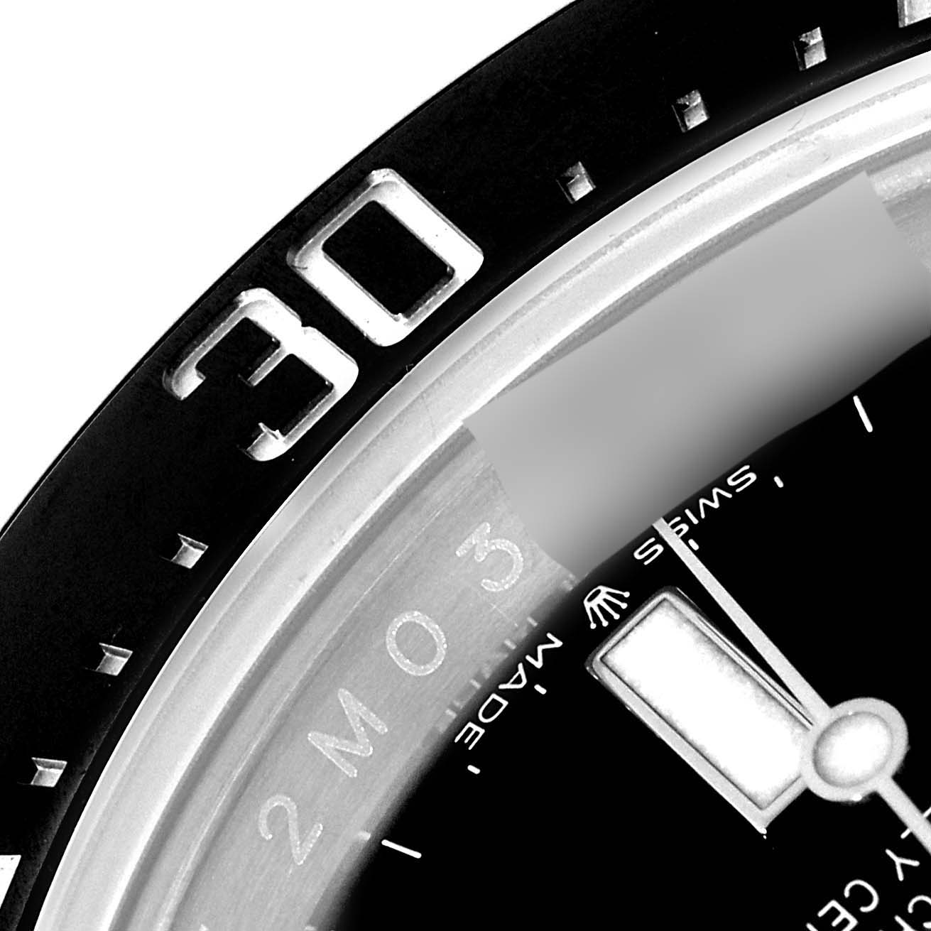 This close-up image of the Rolex Sea-Dweller 126600 Men's Stainless Steel Black Dial 126600 Men's Stainless Steel Black Dial shows part of the bezel and a section of the dial with hour markers and hands.